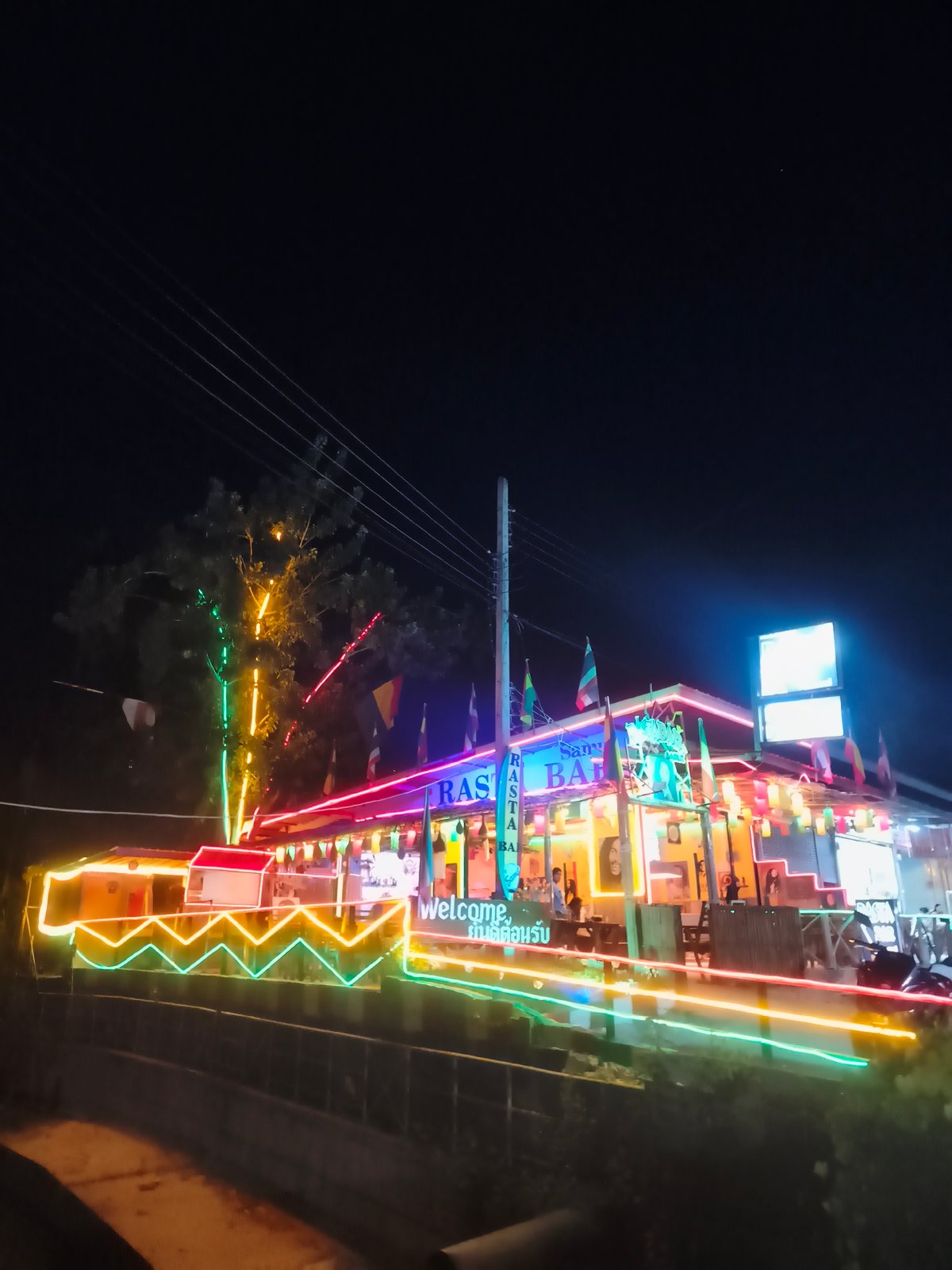 Neon-lit bars illuminate Baan Chaweng nightlife district