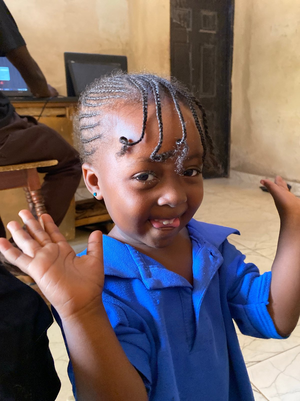 Young girl dances joyfully indoors in Kuru Dungus, Nigeria