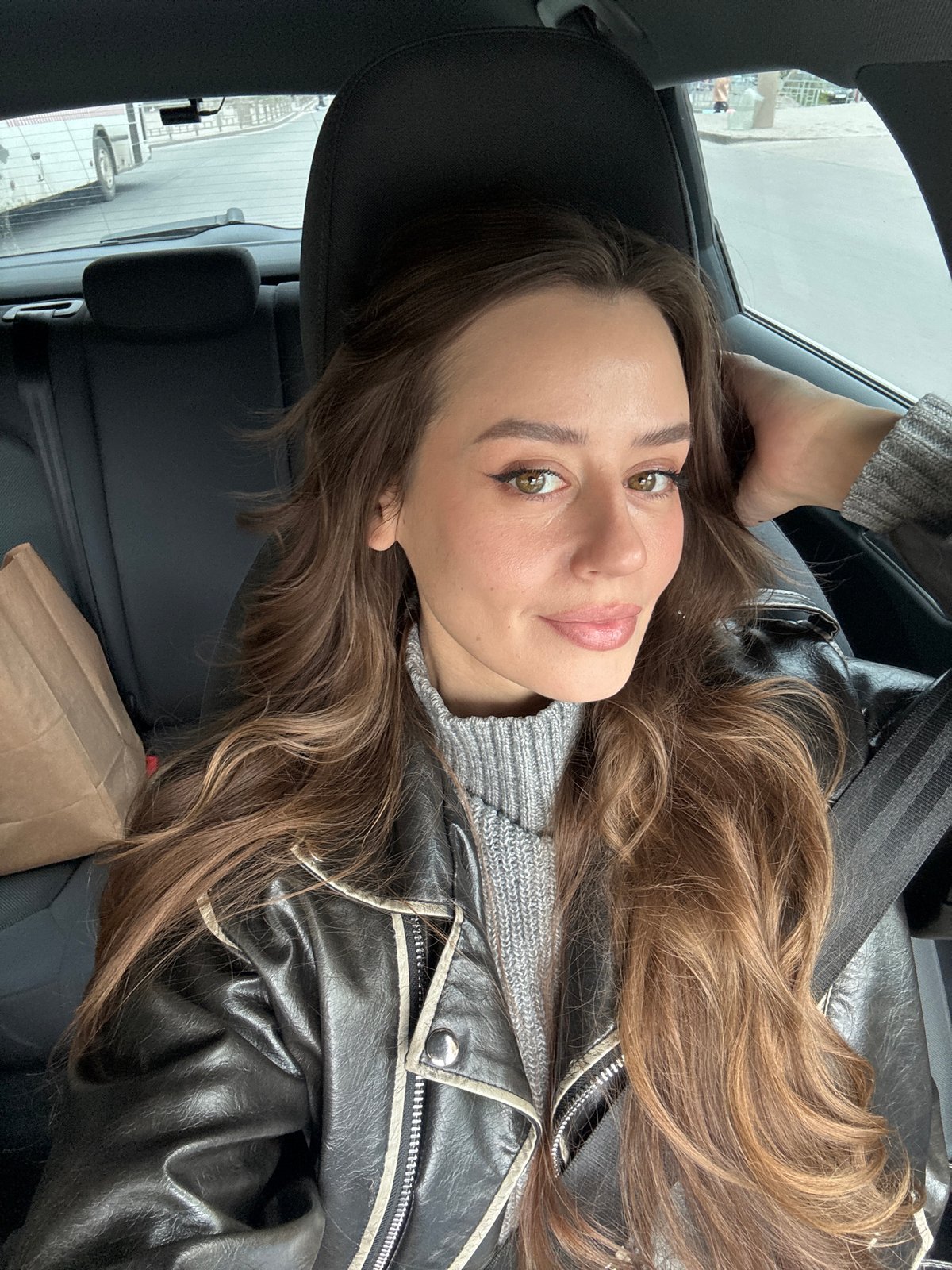 Woman takes selfie in parked car in Krasnoyarsk