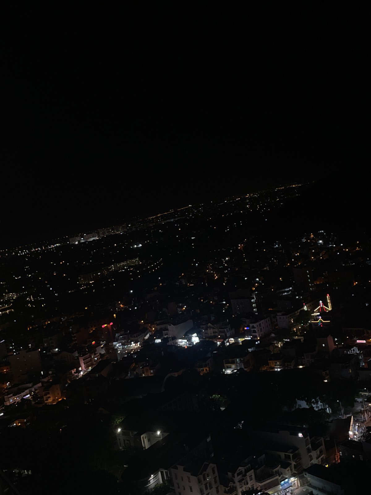 Night in a Nha Trang apartment, city glowing outside