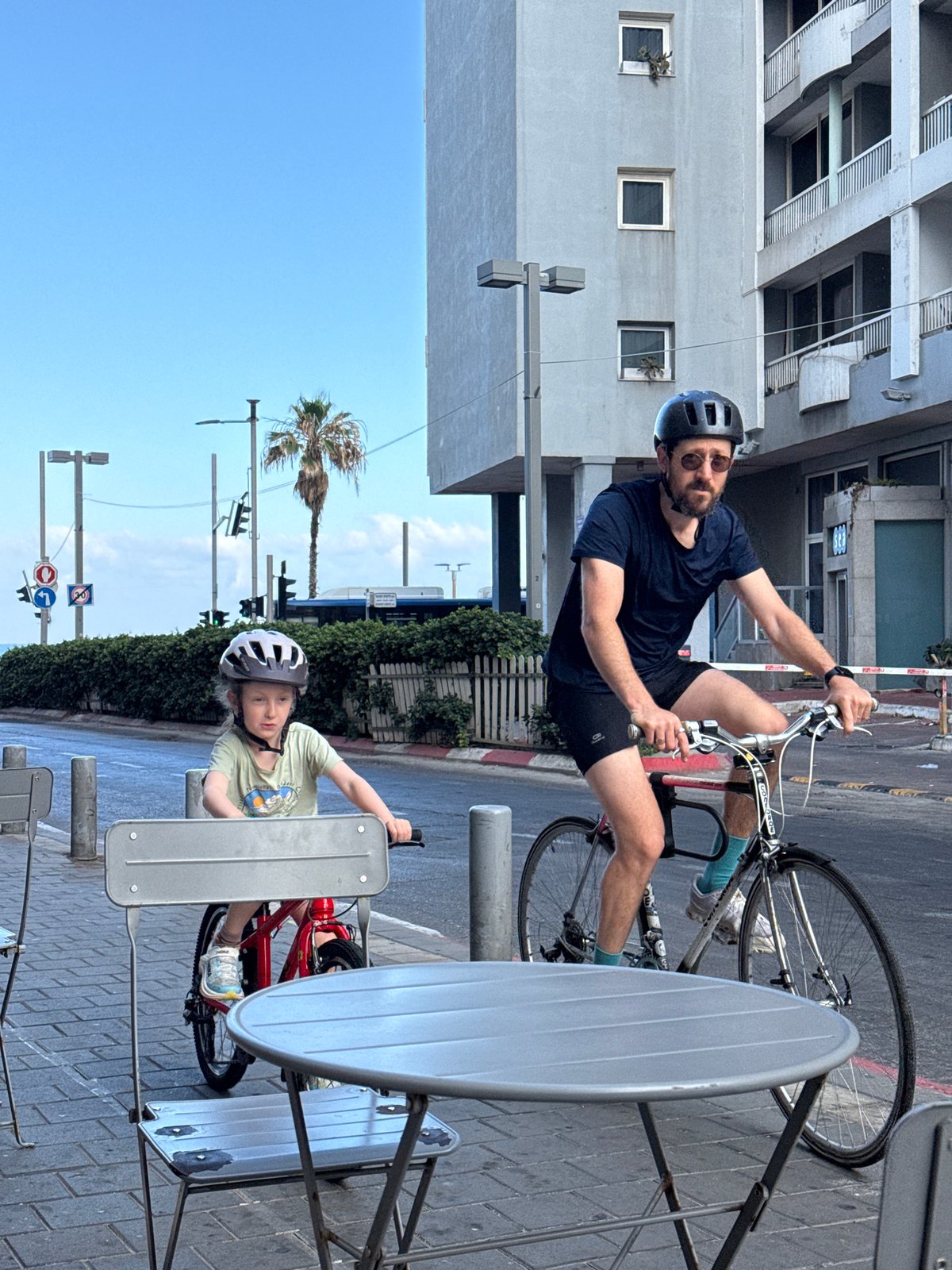 Cyclists and a casual selfie on a Tel Aviv morning