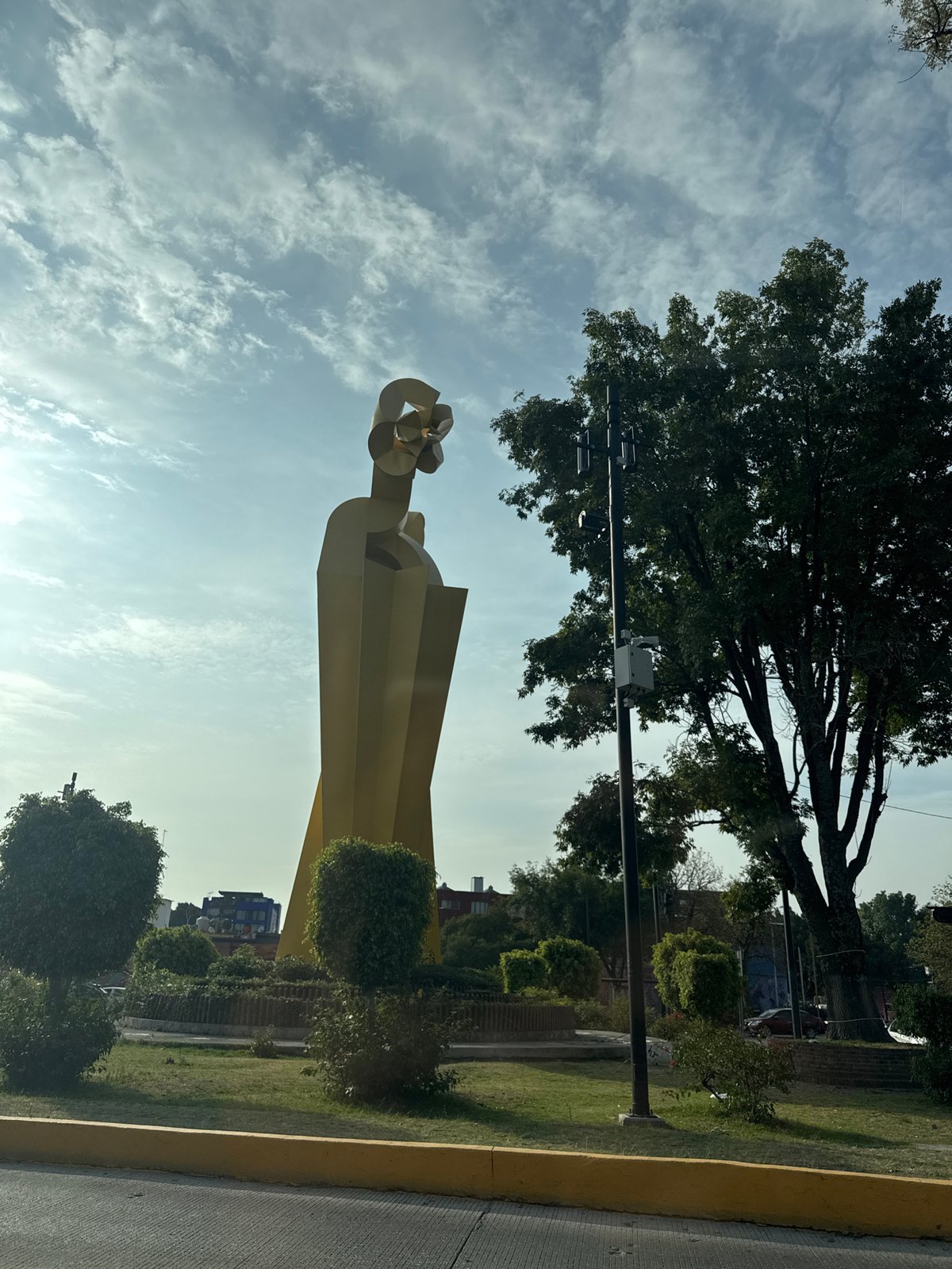 Street scenes and yellow sculpture documented in Puebla