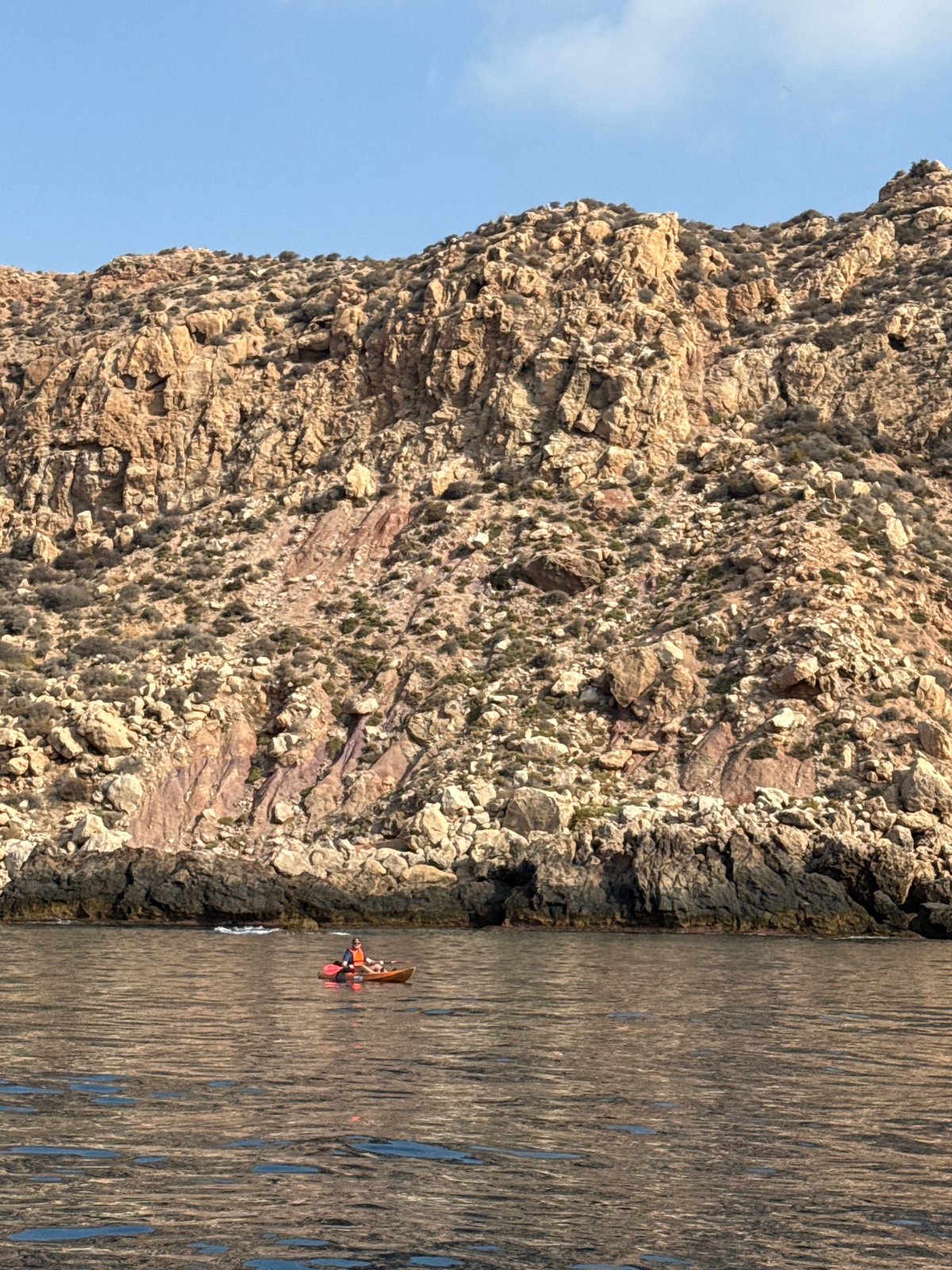 Rugged Spanish coastline cliffs with striking mineral vein exposed