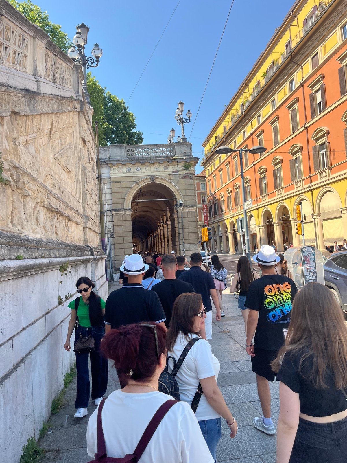 Morning pedestrian activity captured in Bologna's historic porticoes