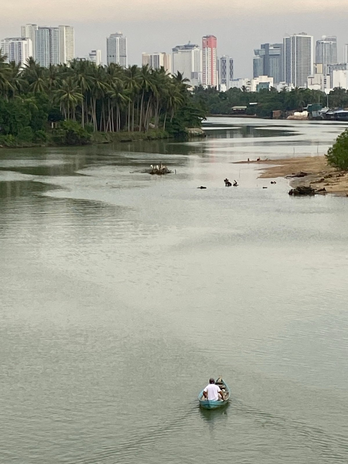 Nha Trang river views with city skyline on a cloudy morning