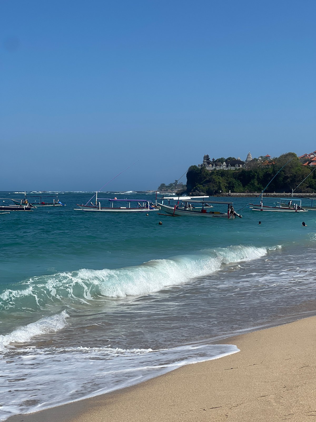 Relaxed beach morning at Kuta Selatan with coastal temple views