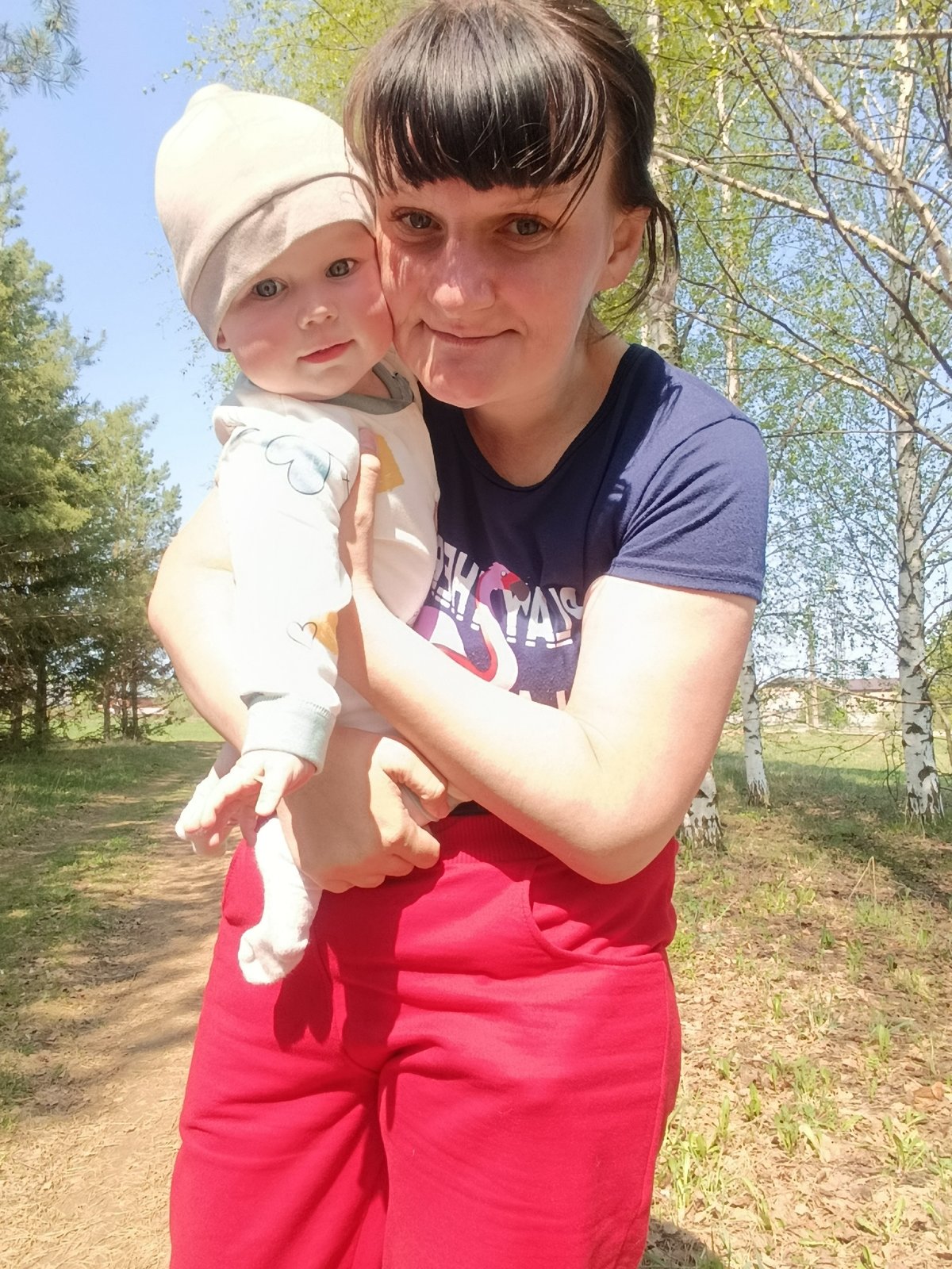 Mother and baby enjoy bubble play in Russian birch grove