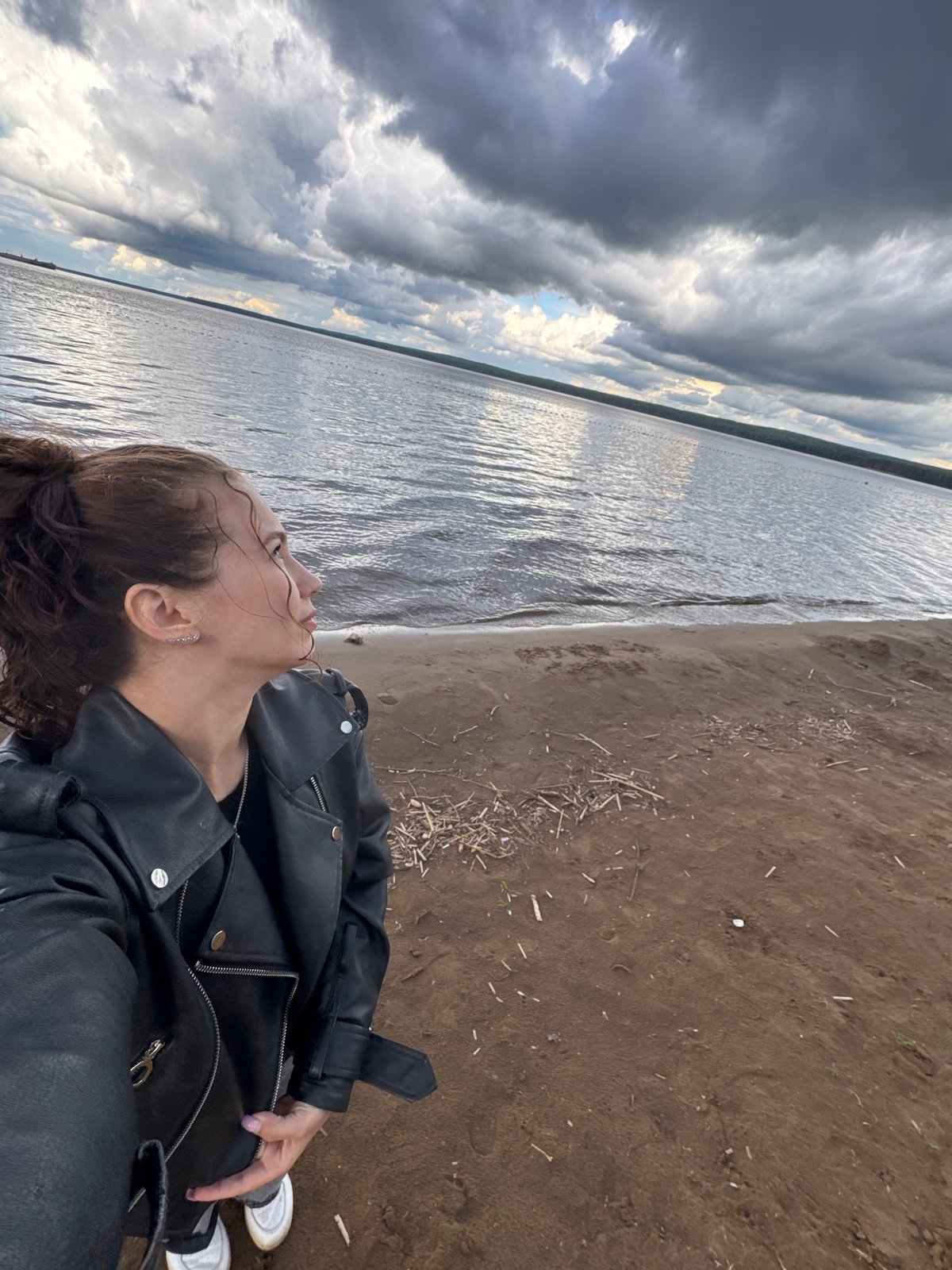 Woman photographed at waterfront in Chaikovsky, Russia during afternoon