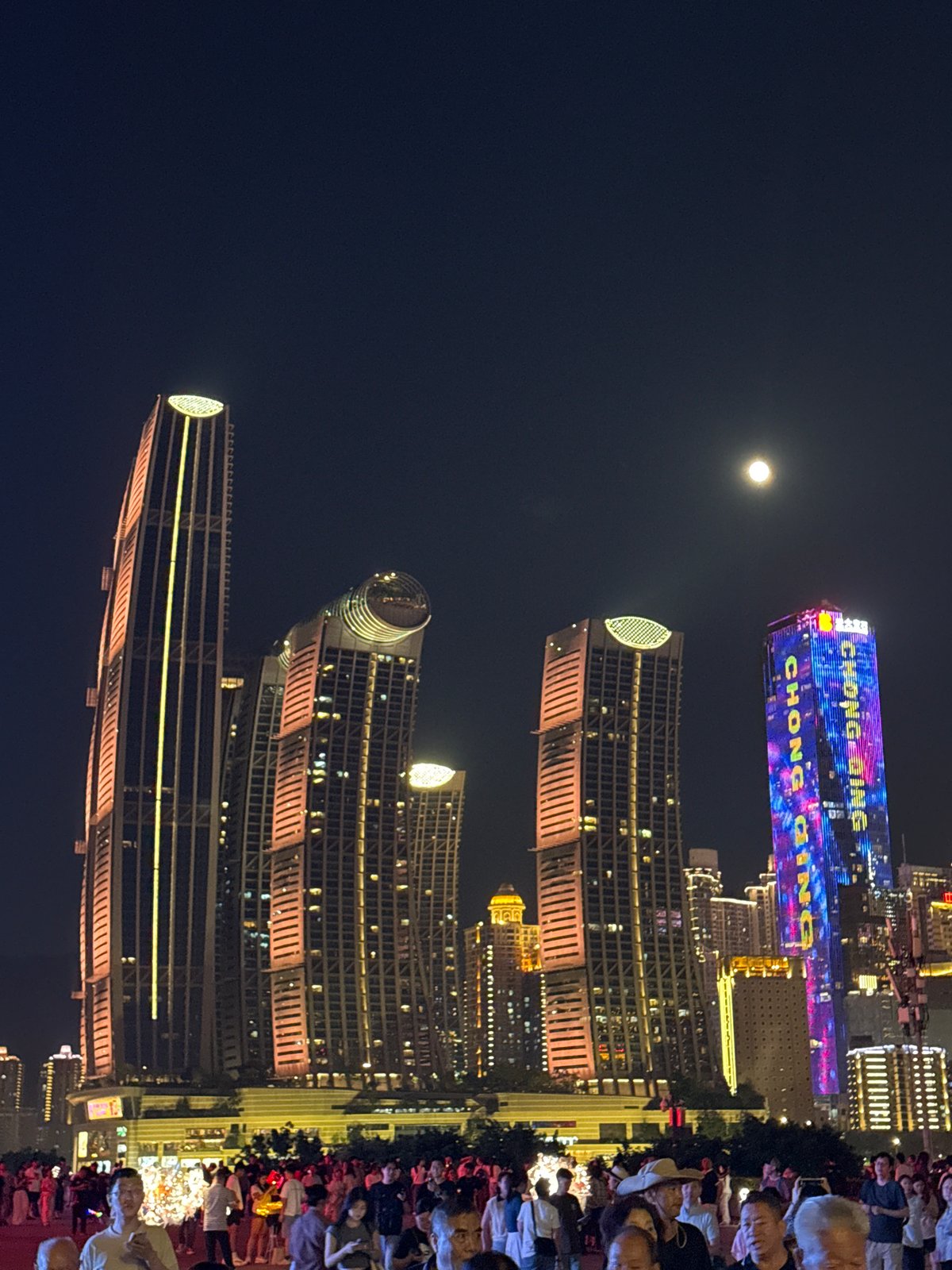 Chongqing's illuminated skyline and evening pedestrian activity captured