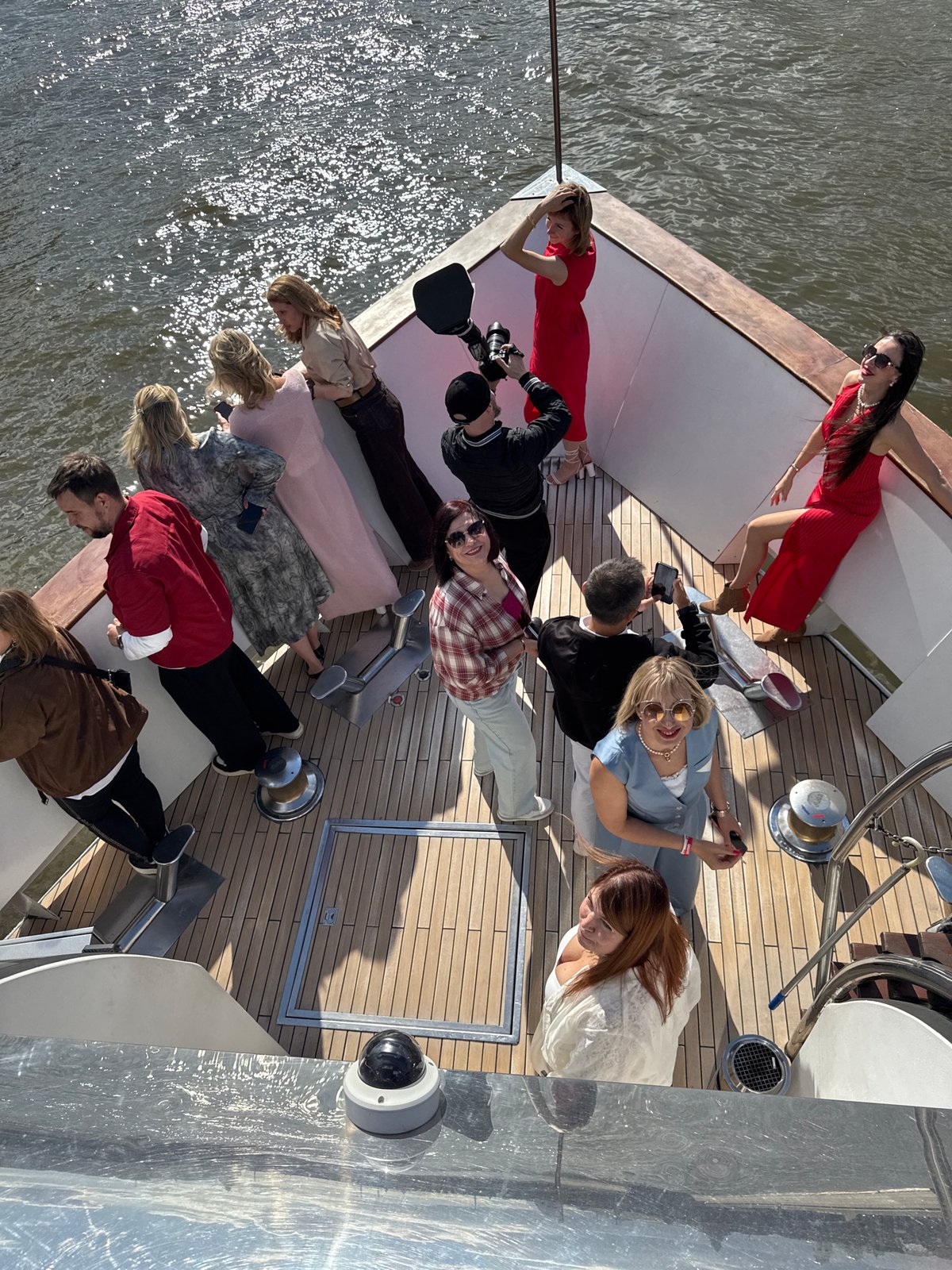 Yacht gathering with photographer captures two women in red
