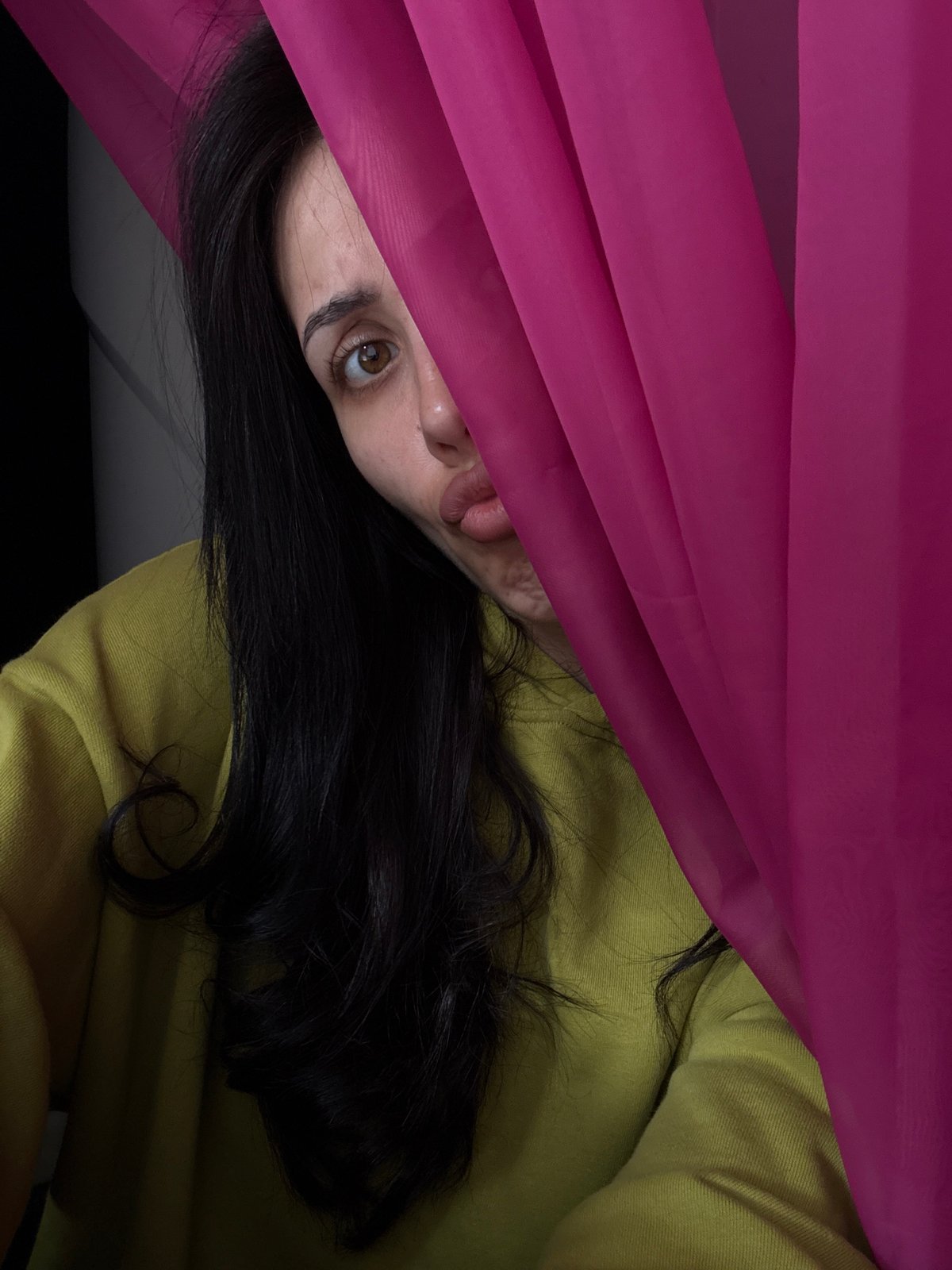 Playful moment captured under magenta fabric in Votkinsk