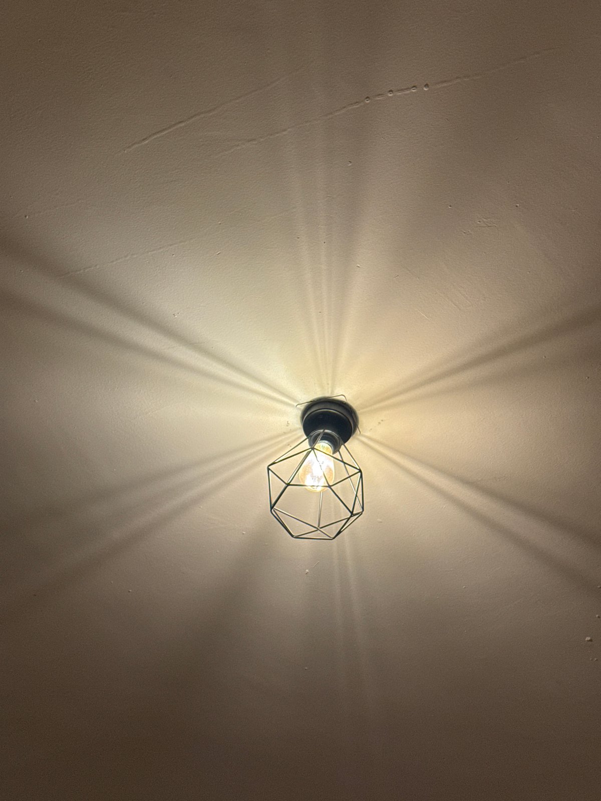 Wall-mounted cage light fixture observed in Oaxaca City