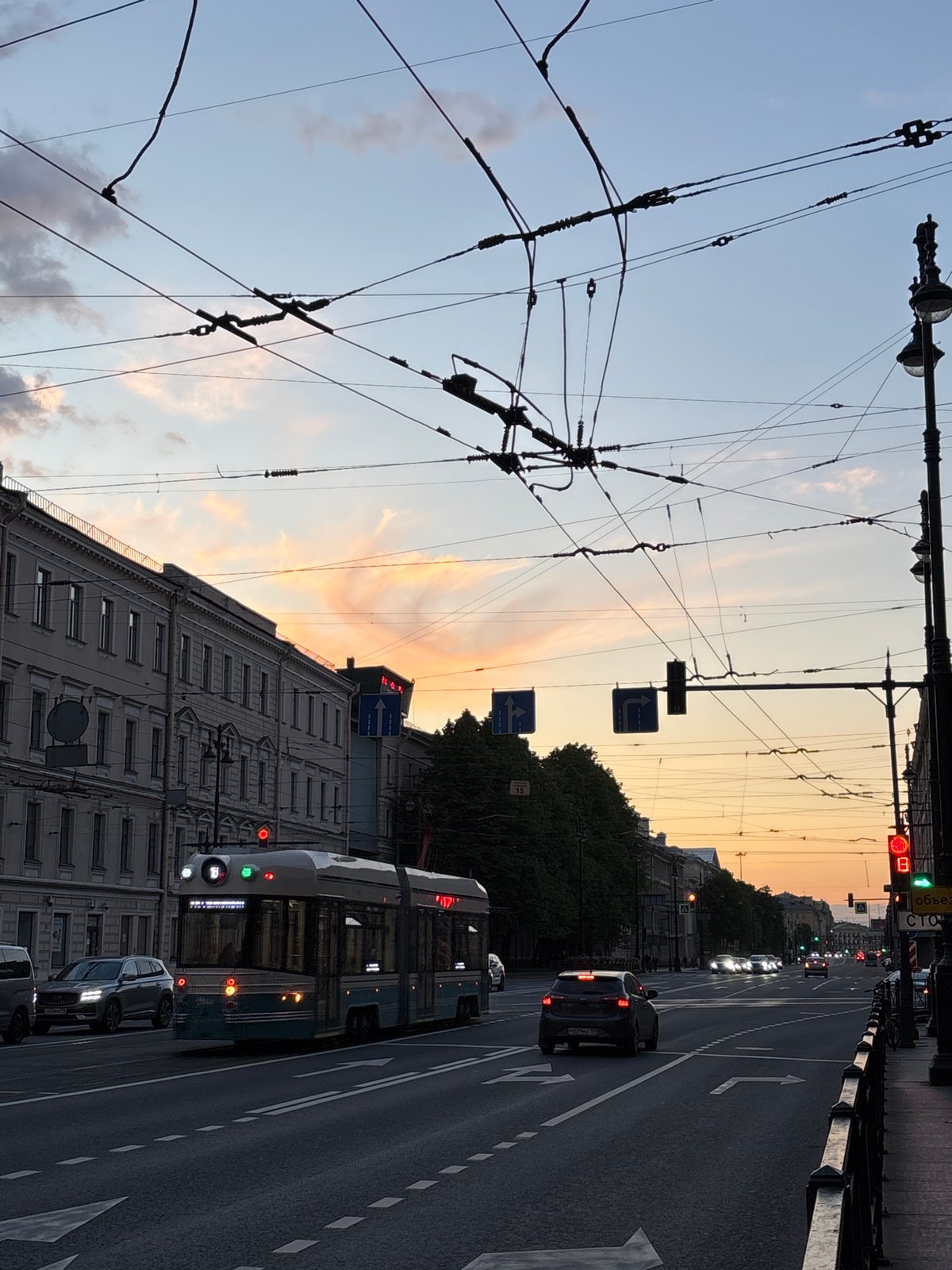 Twilight street scene documented in Saint Petersburg showing trolleybus infrastructure