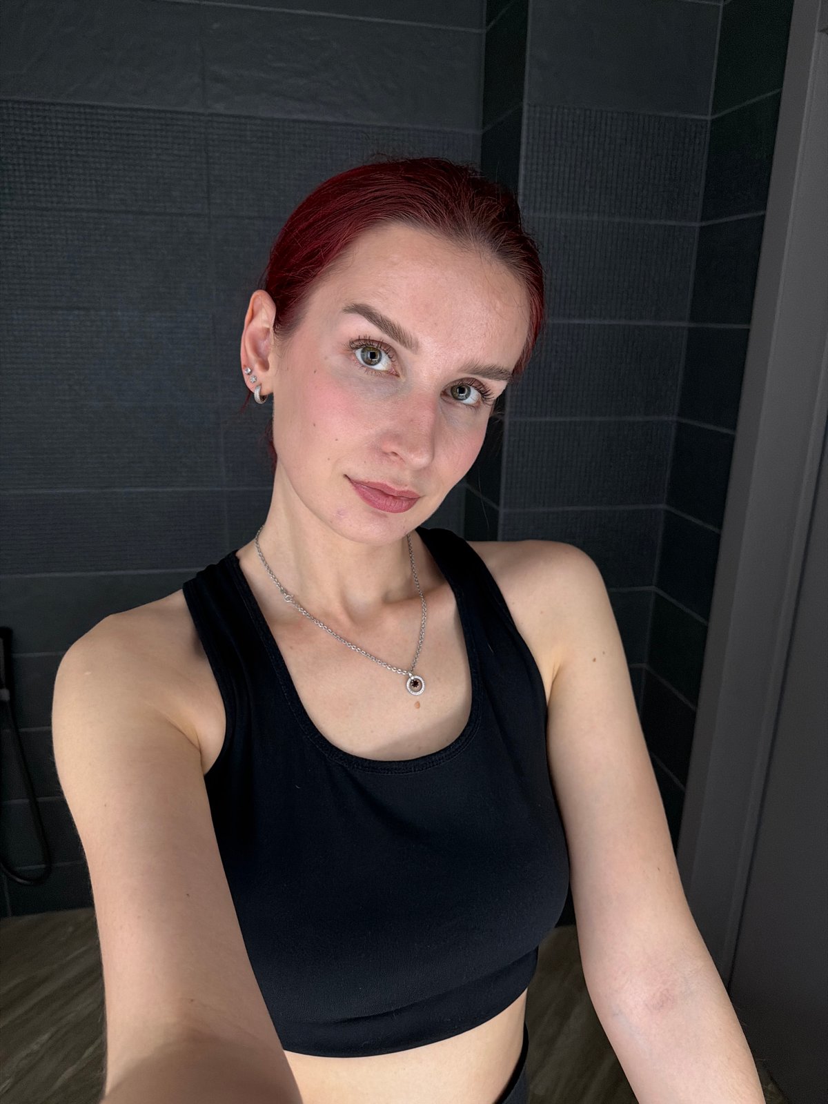 Woman takes bathroom selfies, heart drawn on steamy mirror