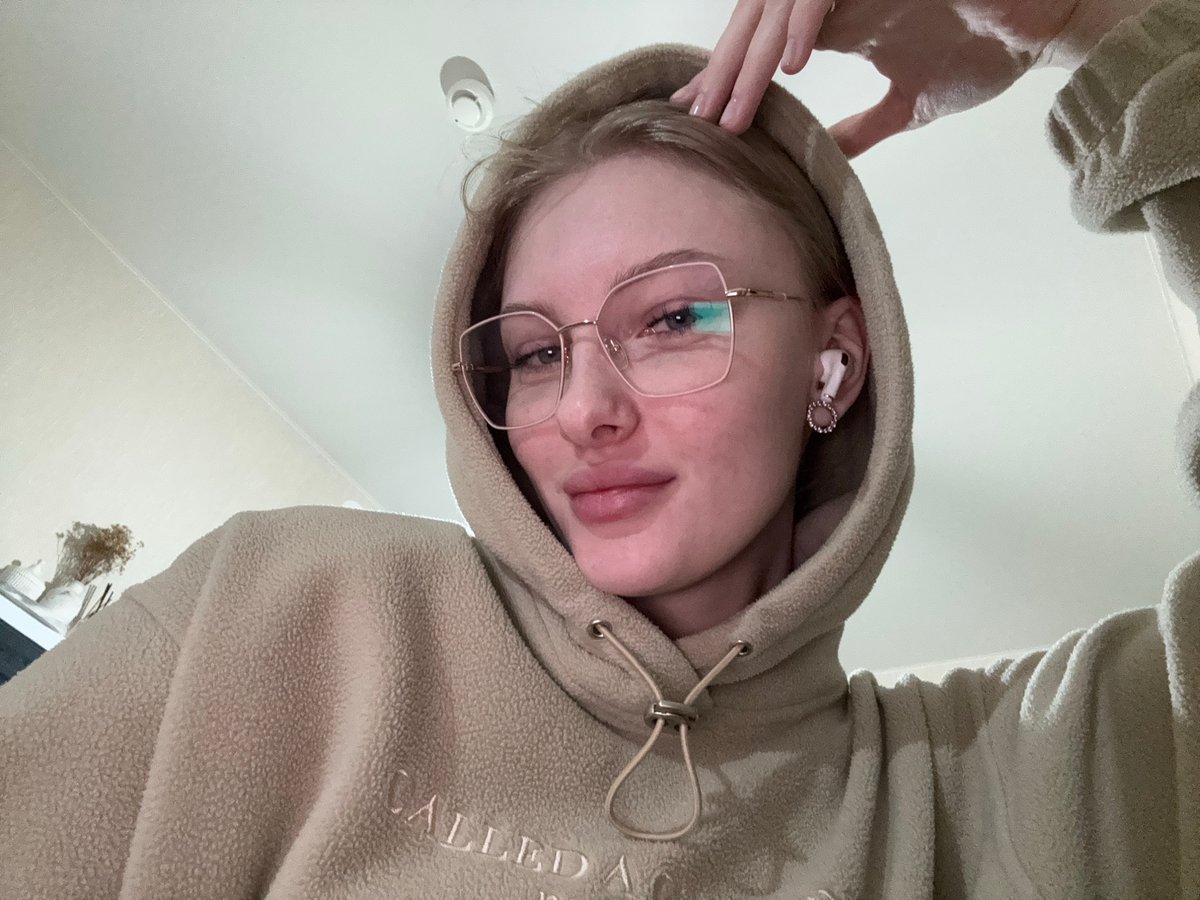 Woman takes selfies in beige hoodie in Perm