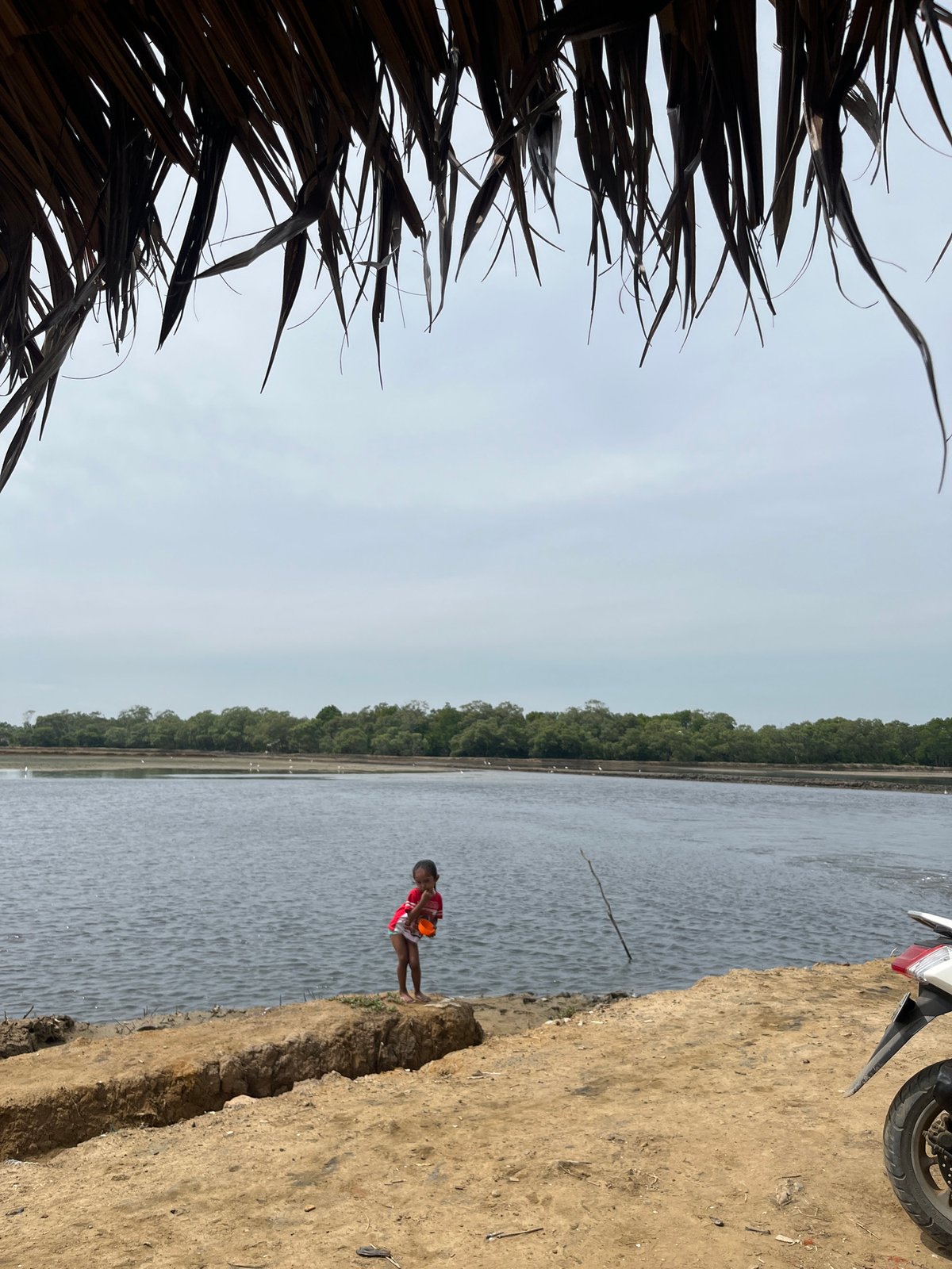 Under a thatched roof, looking out at the Dayahtuha coast.
