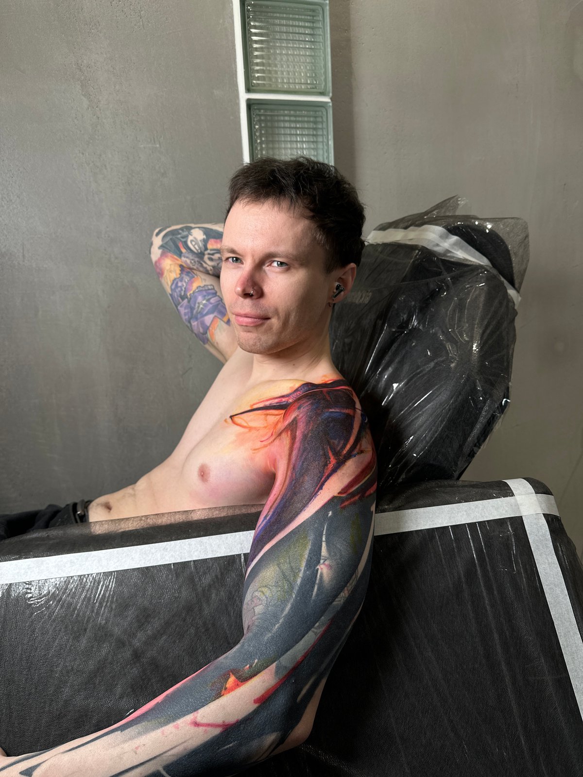 Tattoo artist works on client's arm in Moscow