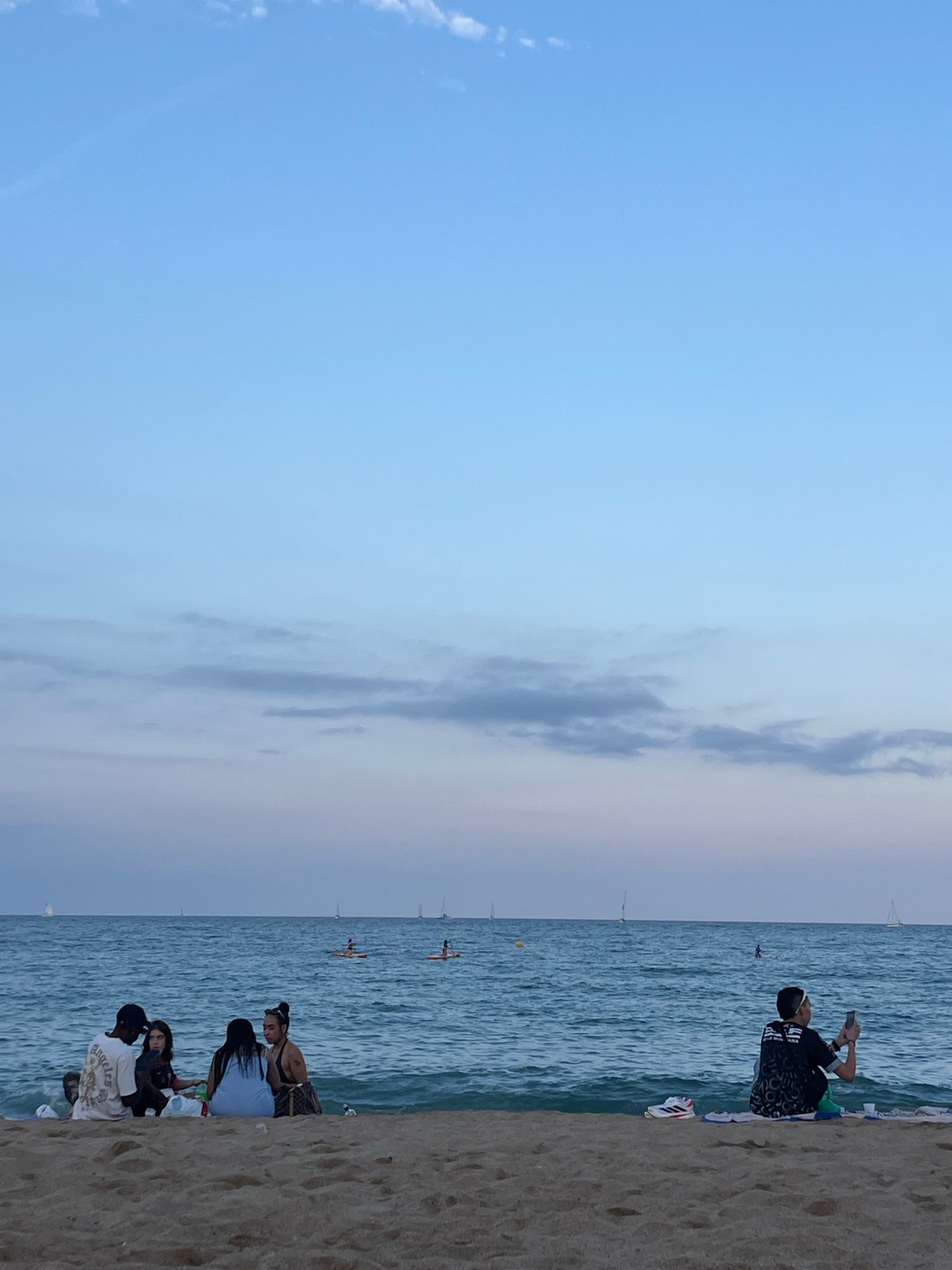 Evening beach leisure activities captured across Barcelona coastline