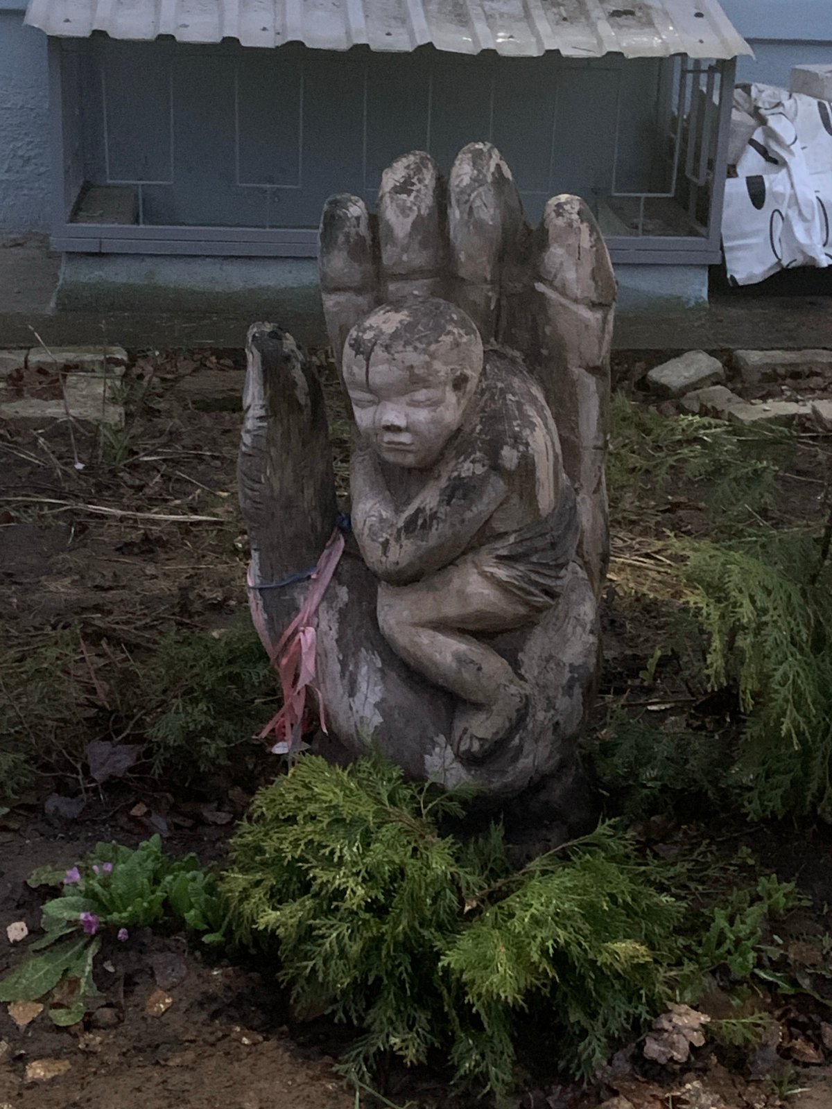 Wooden hand-child sculpture spotted in Chaikovsky garden