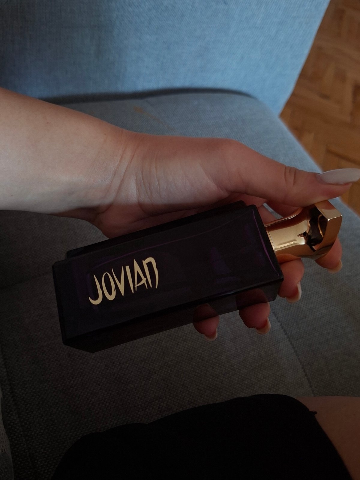 Person holds Jovian perfume bottle in Pleven, Bulgaria