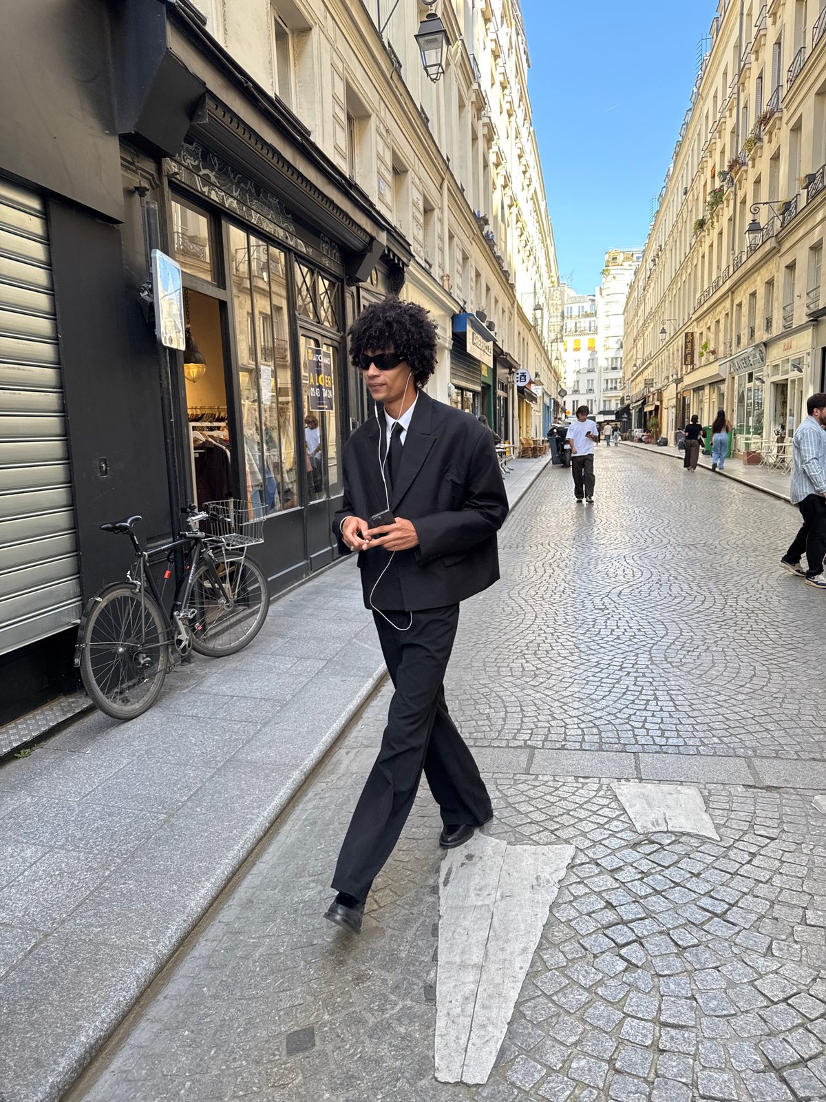 Three young men photographed on Paris cobblestone street
