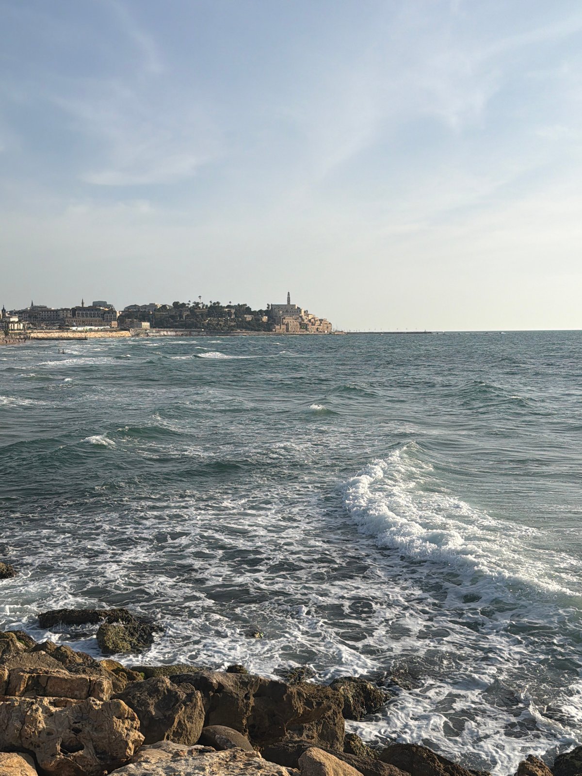 Observer documents Tel Aviv coastal scenes during sunny afternoon
