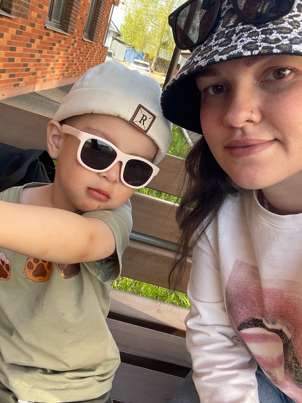 Child rests outdoors, decorated cat box observed in Izhevsk