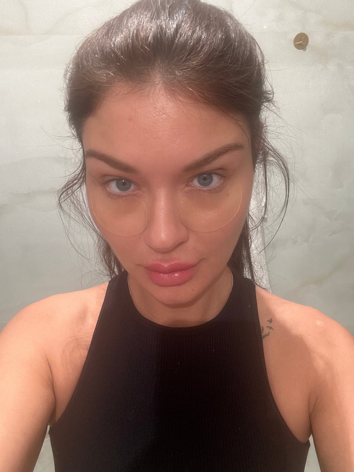 Woman applies skincare patches in Moscow selfie session