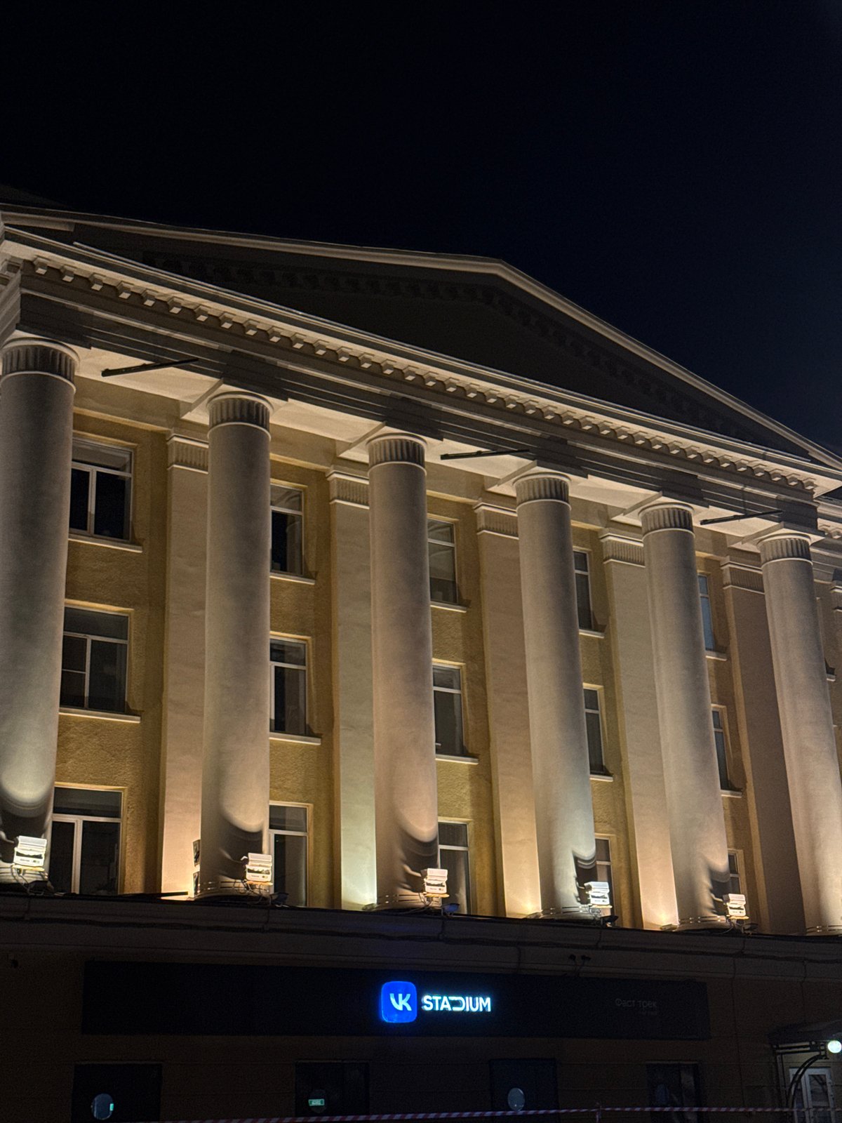 Neoclassical Moscow building glowing under warm night lights