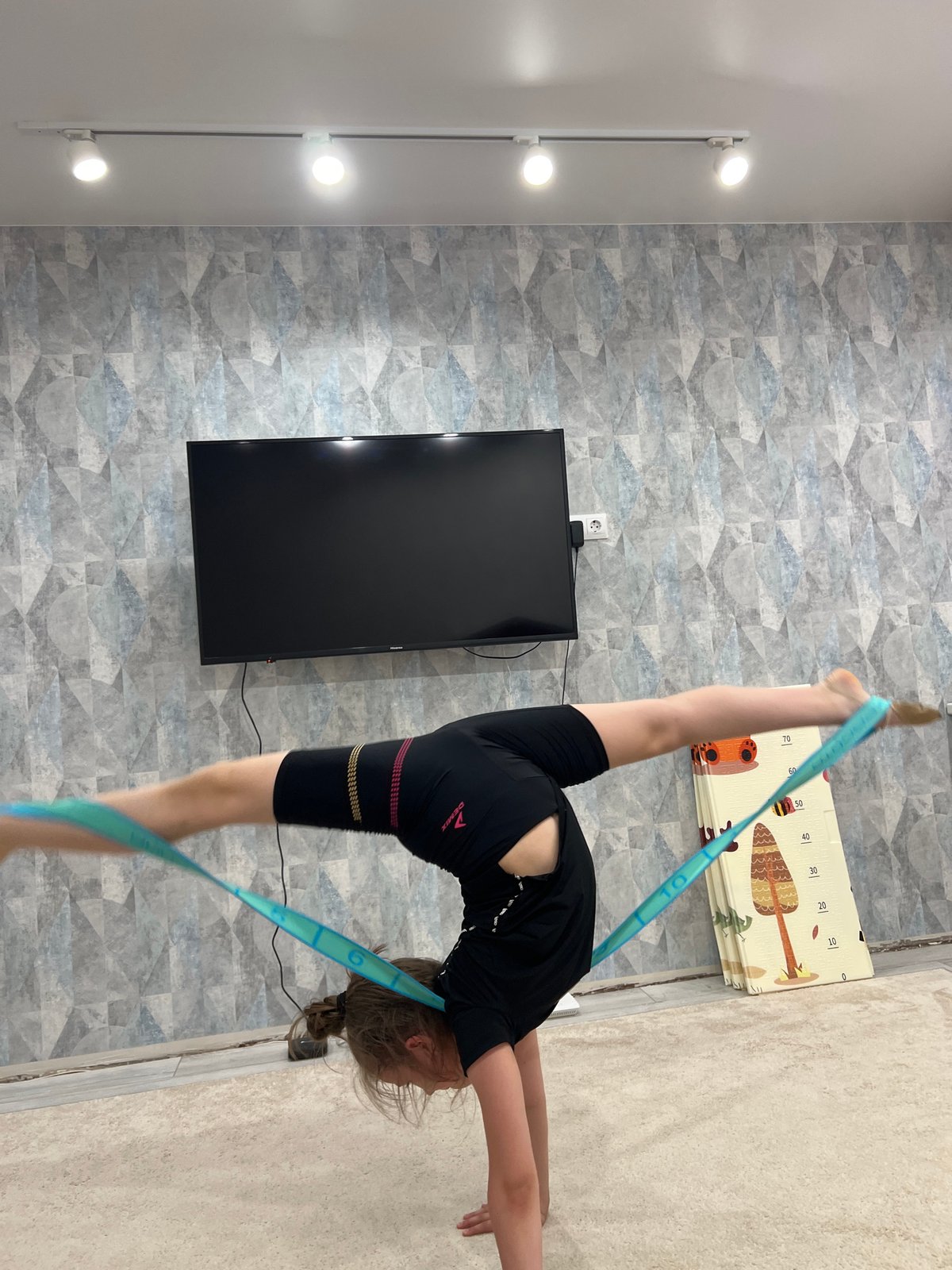 Gymnast trains indoors while spring scenes unfold in Chaikovsky