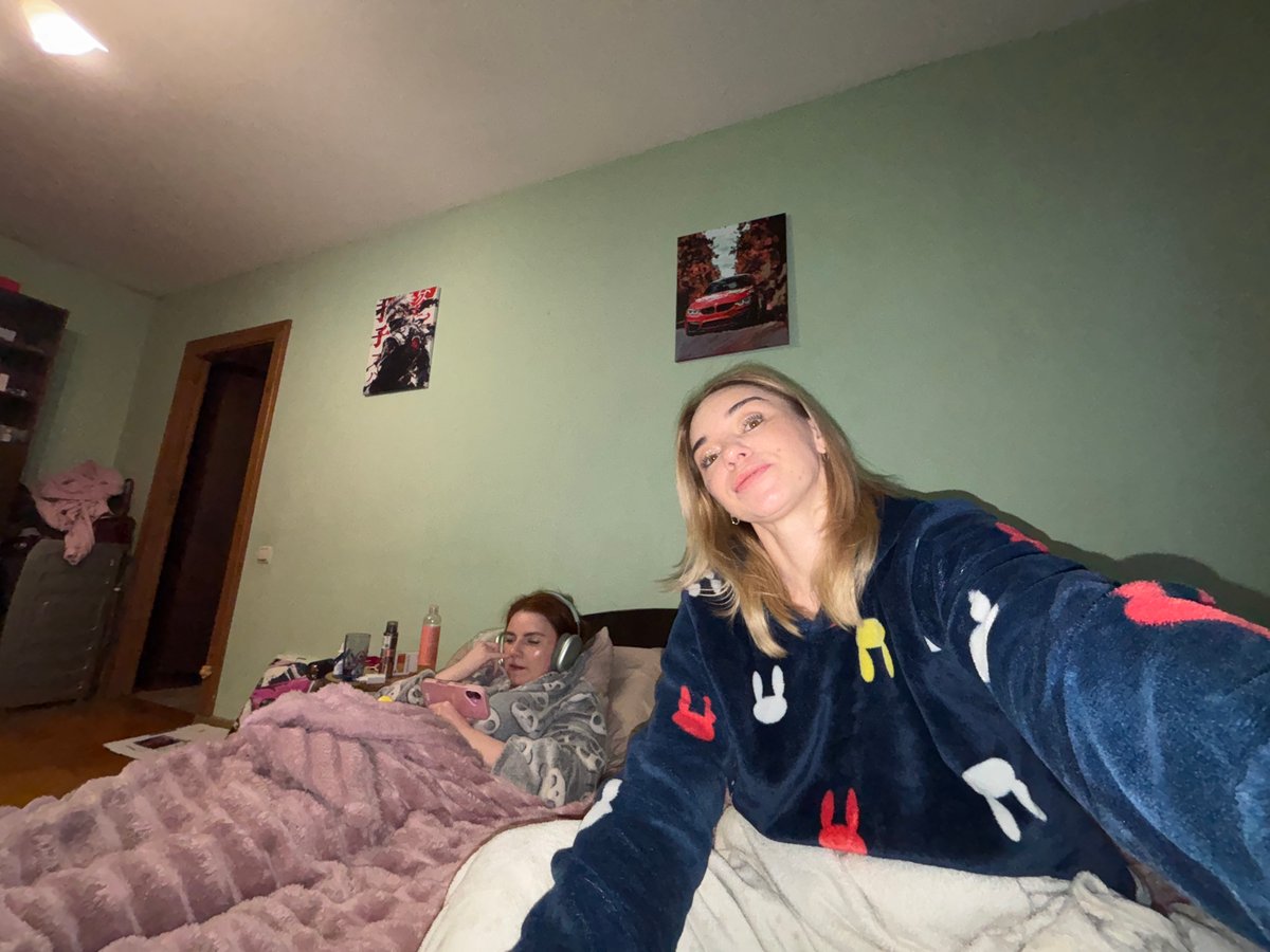 Women documented in casual bedroom scenes during evening hours