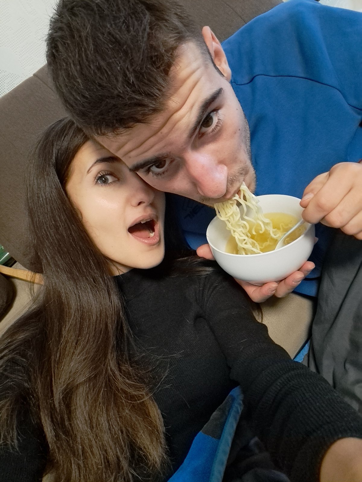 Couple shares noodle meal with decorative spoons in Bulgaria
