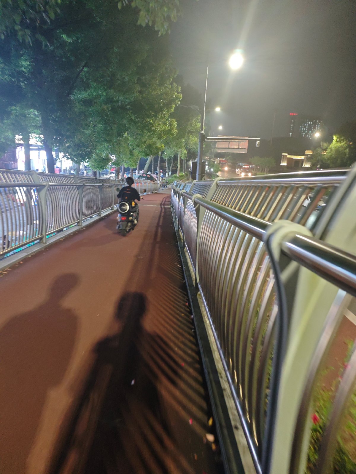 Nighttime traffic and pedestrian activity documented in Chongqing tech district