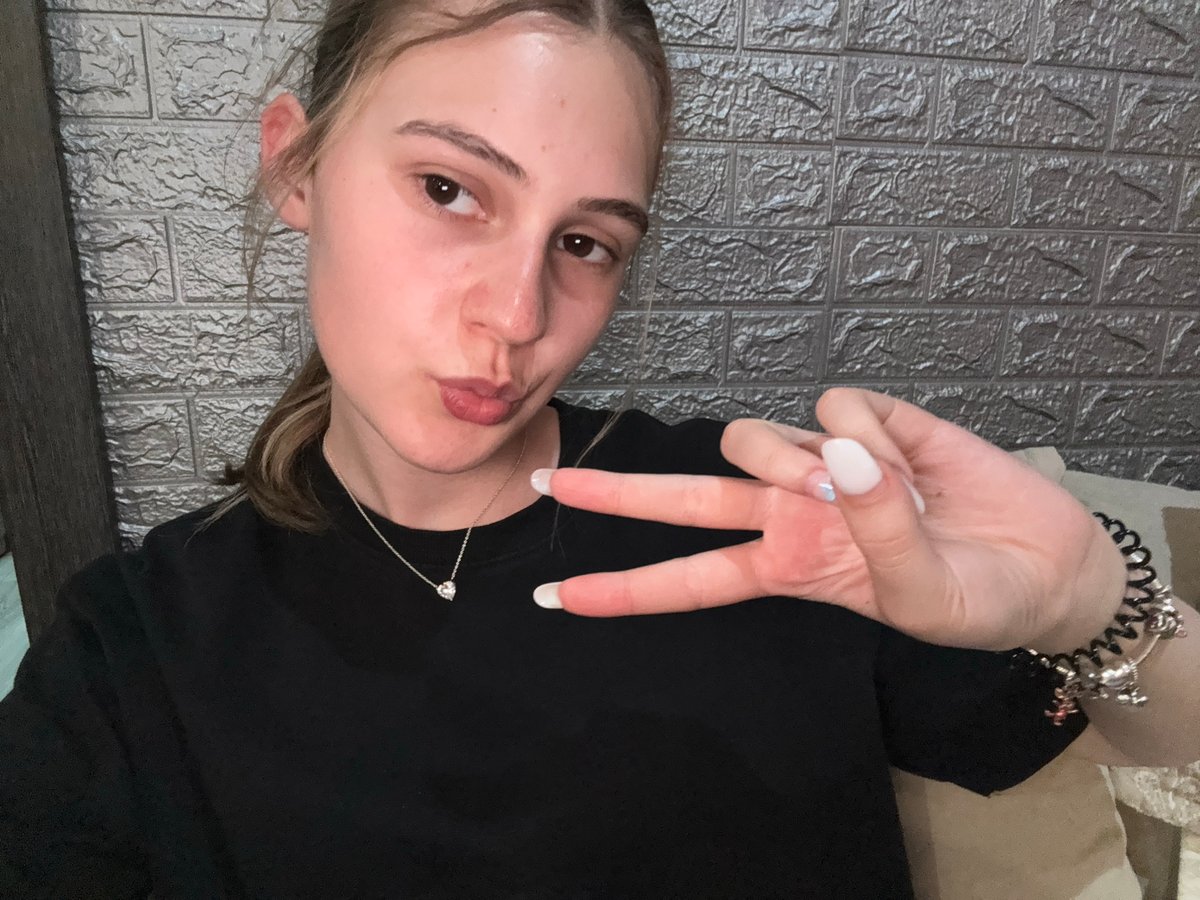 Woman takes selfies on bed in Panagyurishte, Bulgaria