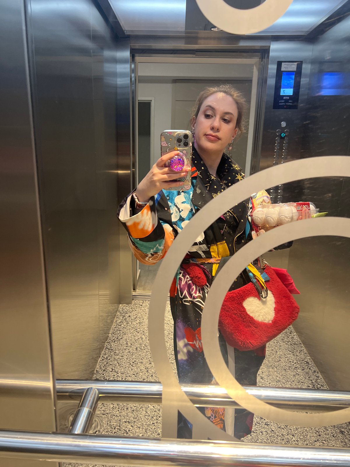Woman takes elevator mirror selfie in Tbilisi
