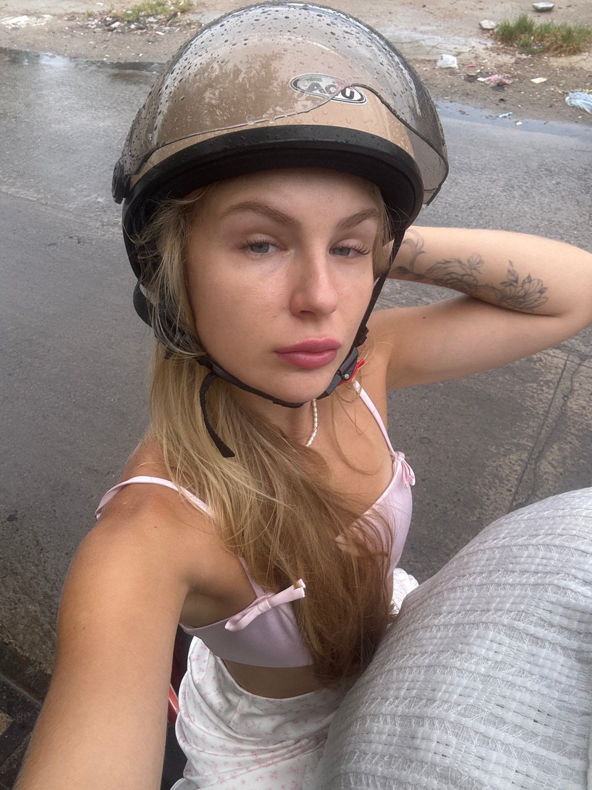 Helmeted person lying down on a street in Nha Trang