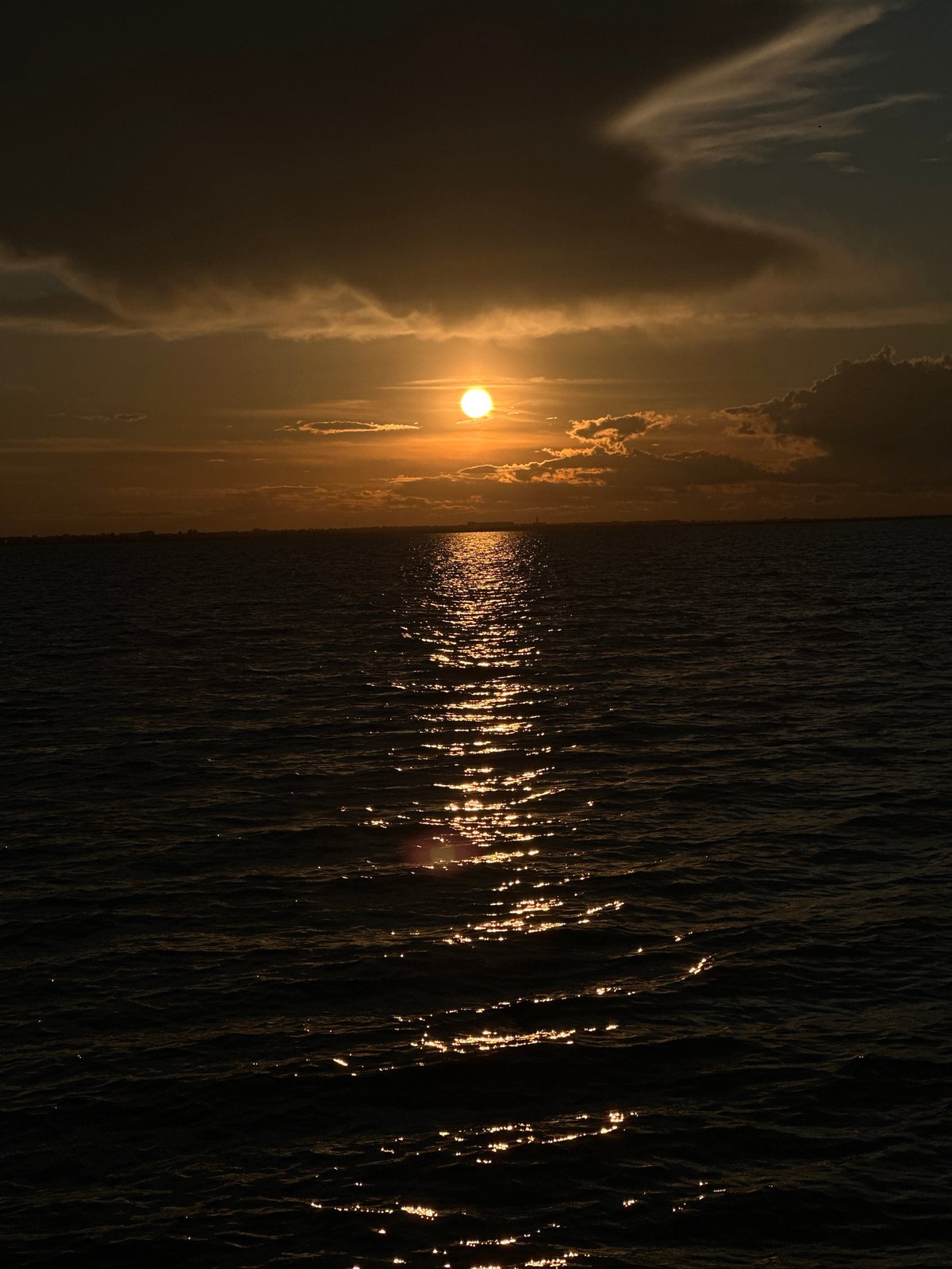 Orange sunset over water in Kokshetau, Kazakhstan