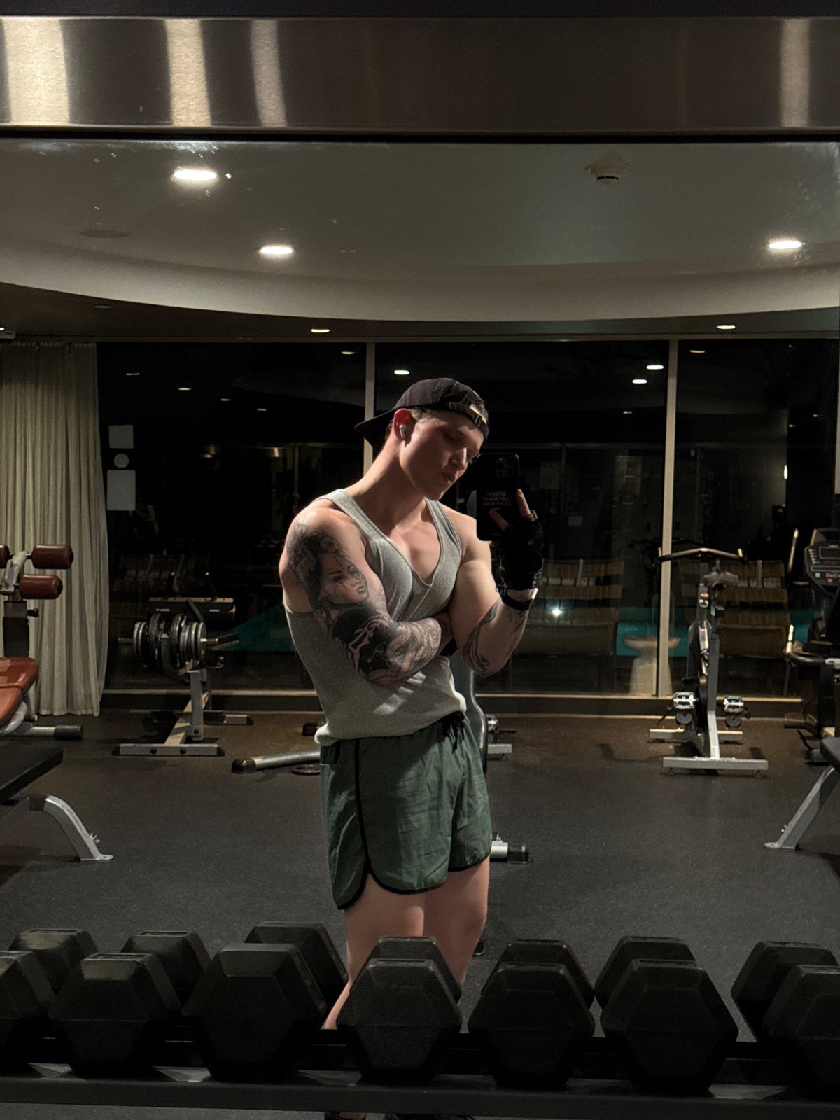 Tattooed fitness enthusiast photographed during morning gym session
