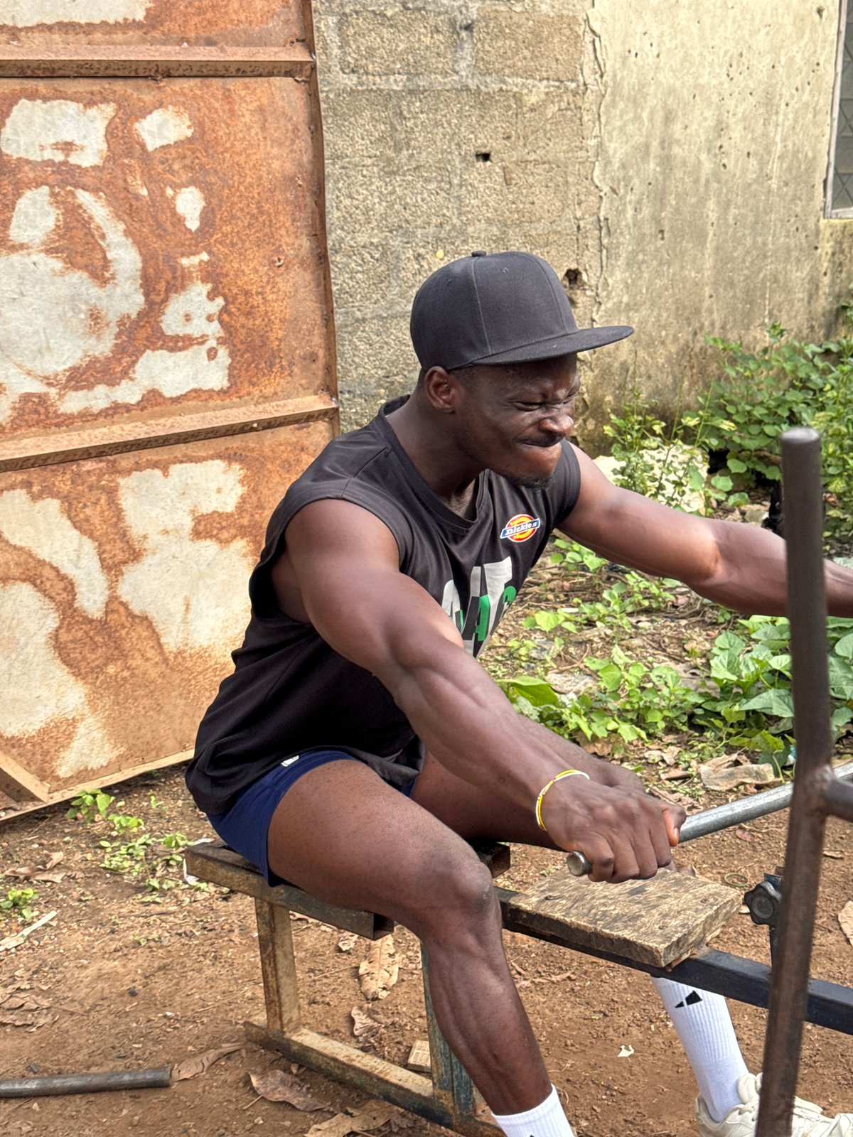 Operating a homemade device on a metal bench in Akwanga