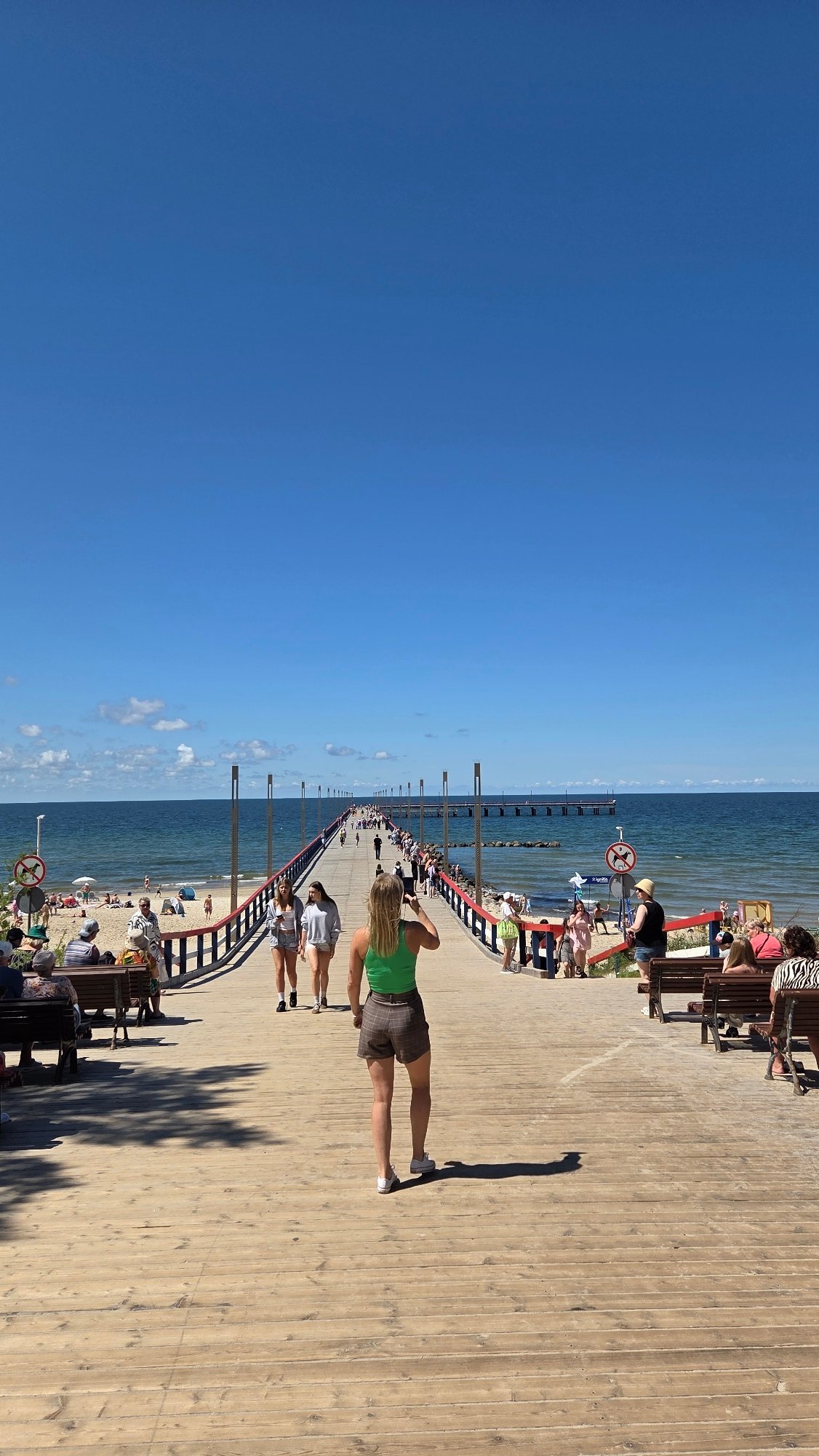 Palanga pier, beach, and amusement area on a sunny summer morning