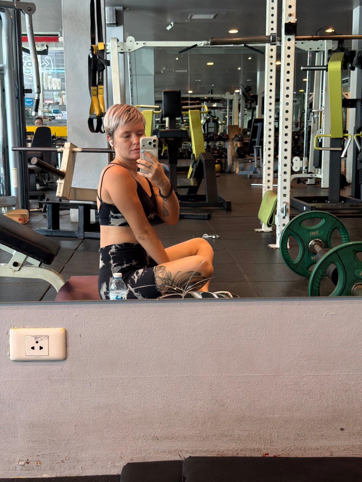 Woman takes gym mirror selfie in Thep Krasatti Thailand
