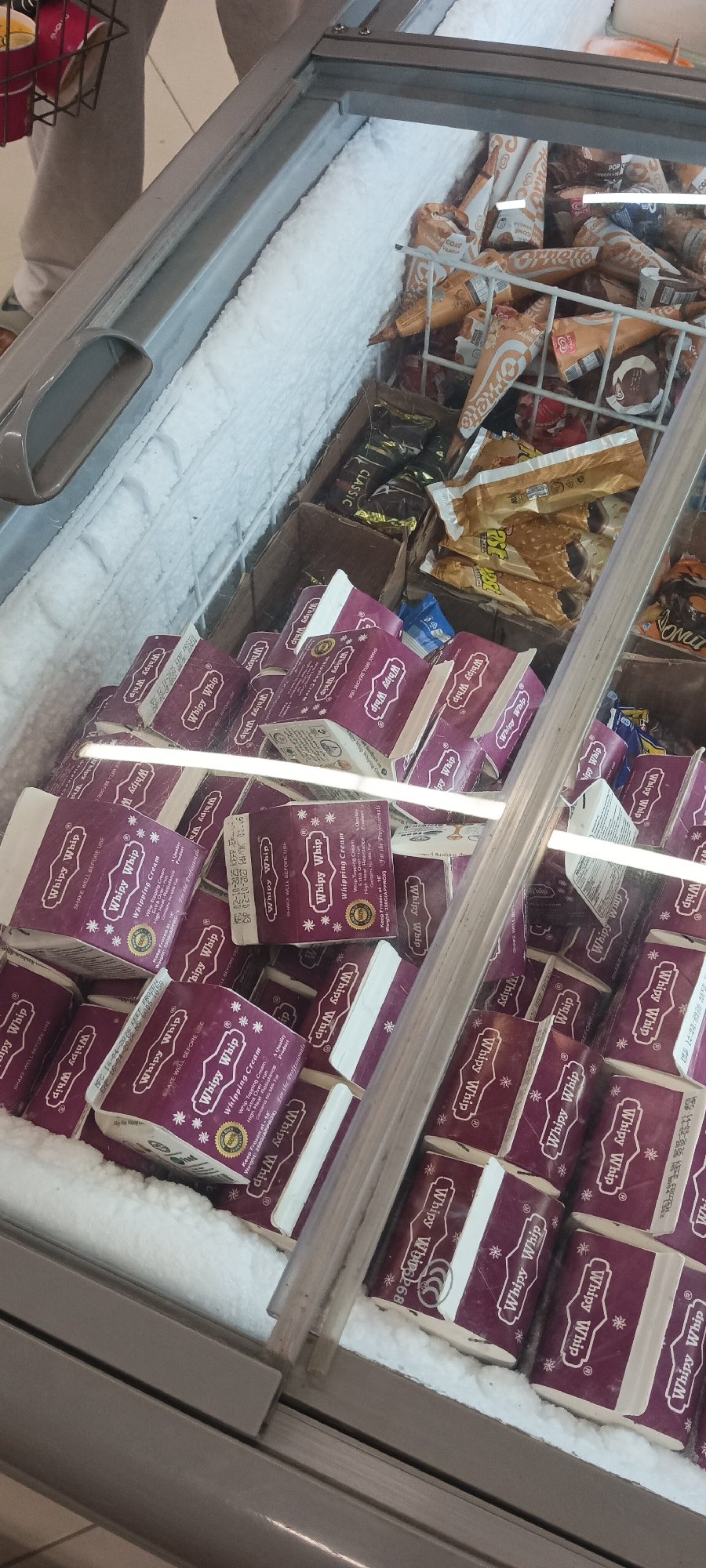 Shopper documents retail displays across Peshawar stores in evening