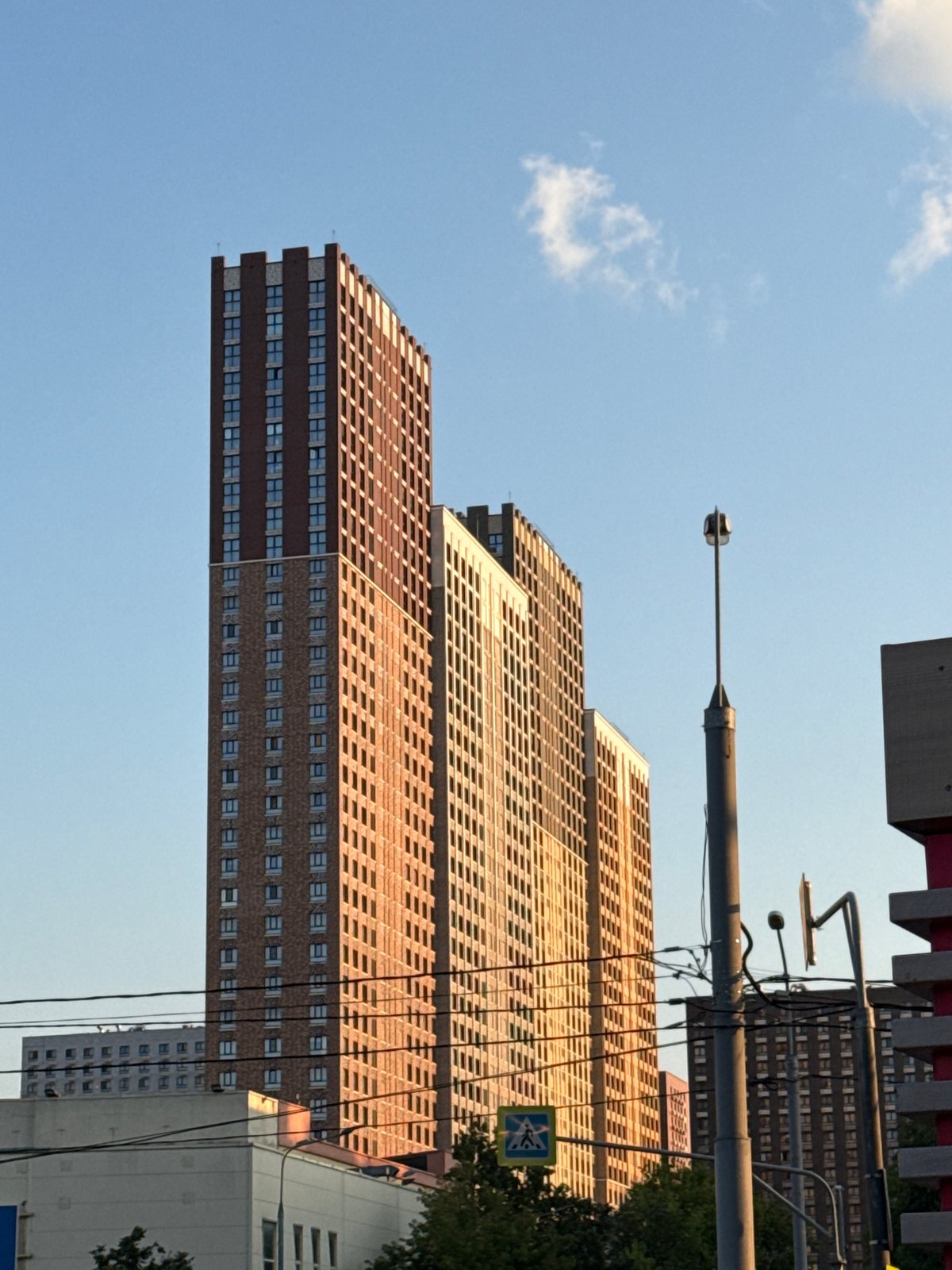 Golden hour light hits Moscow streets and modern apartment blocks
