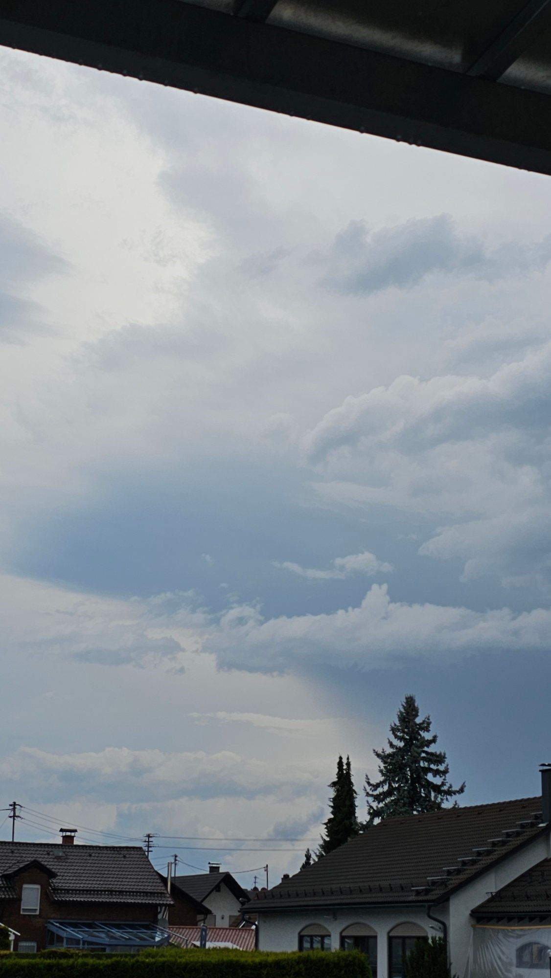 Heavy overcast skies over a Vöhringen neighborhood