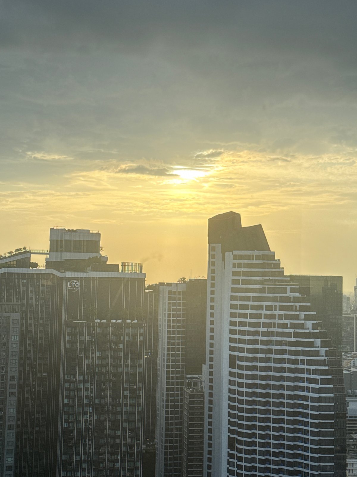 Bangkok skyline from above, golden light and urban sprawl