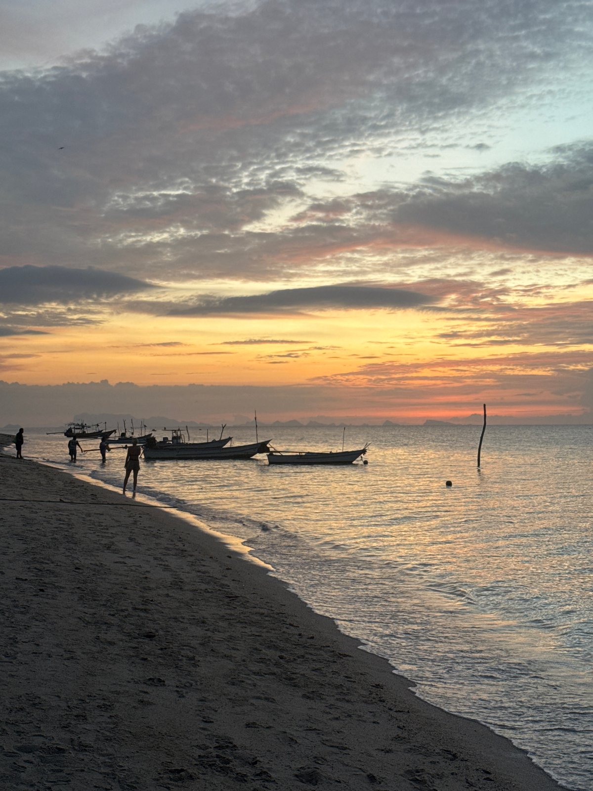 Beach chairs, parked bikes, and island skies in Ko Samui