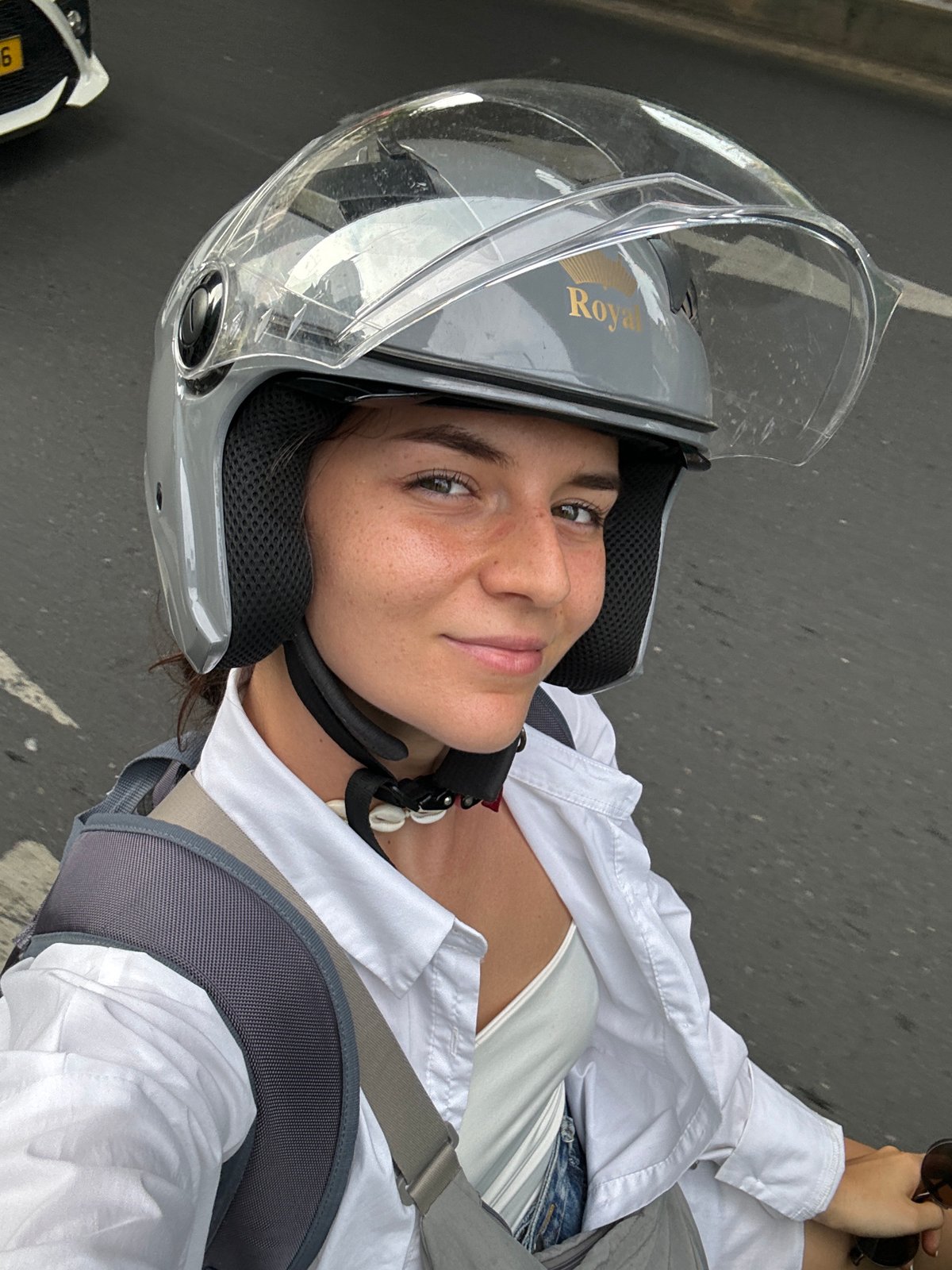 Woman in motorcycle helmet takes selfie in Thủ Đức