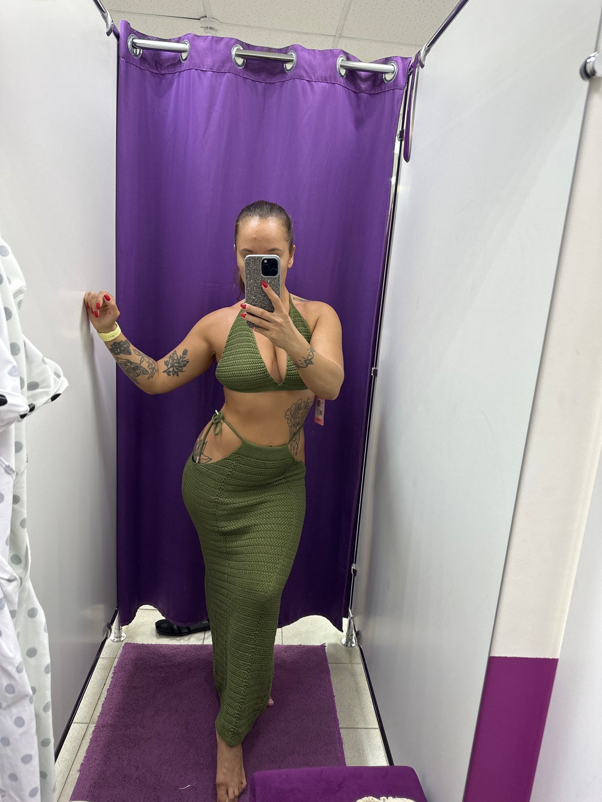 Trying on a green crochet set in a Yuzhnouralsk fitting room