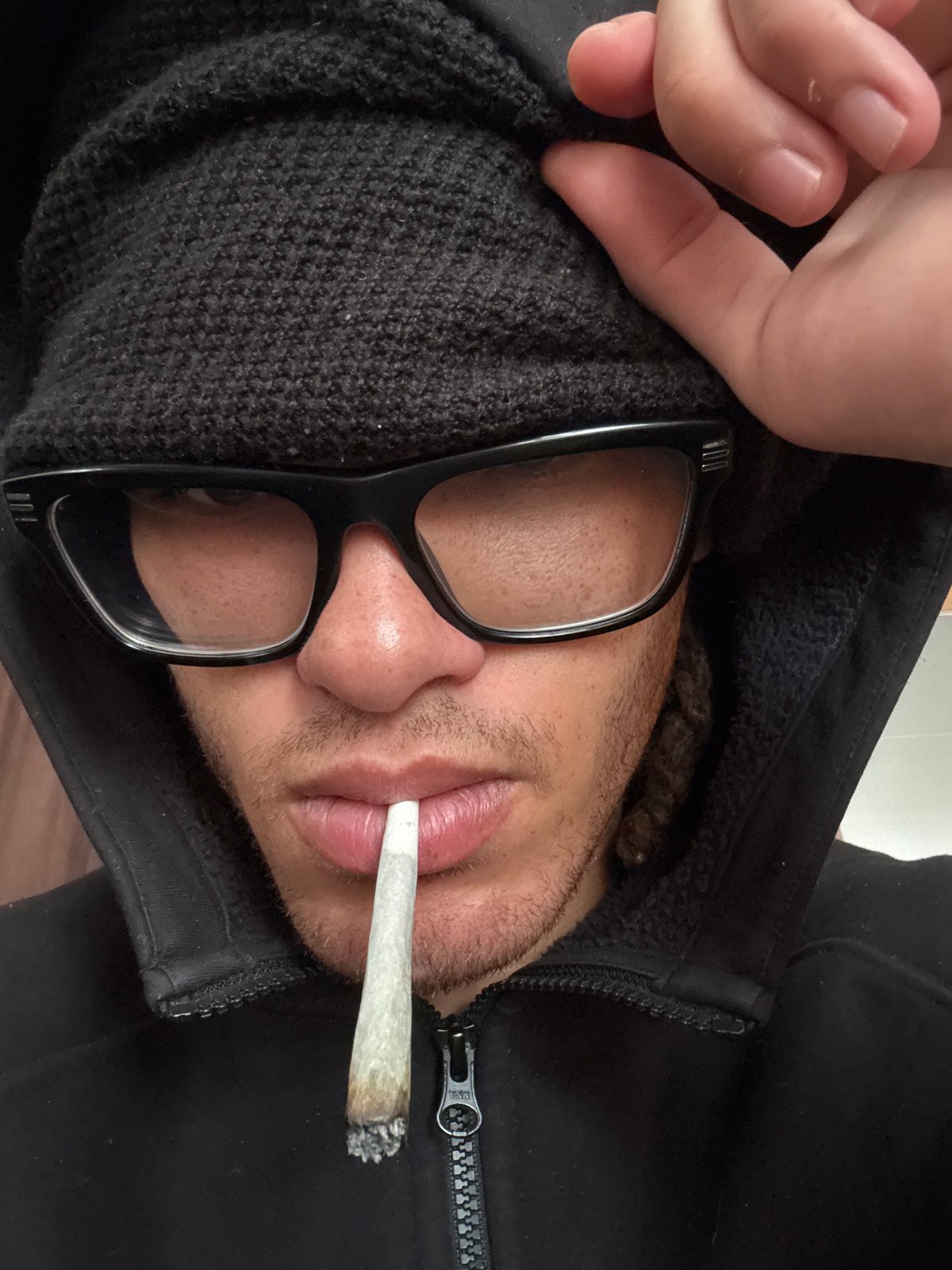Person in glasses and beanie recorded in Orsay