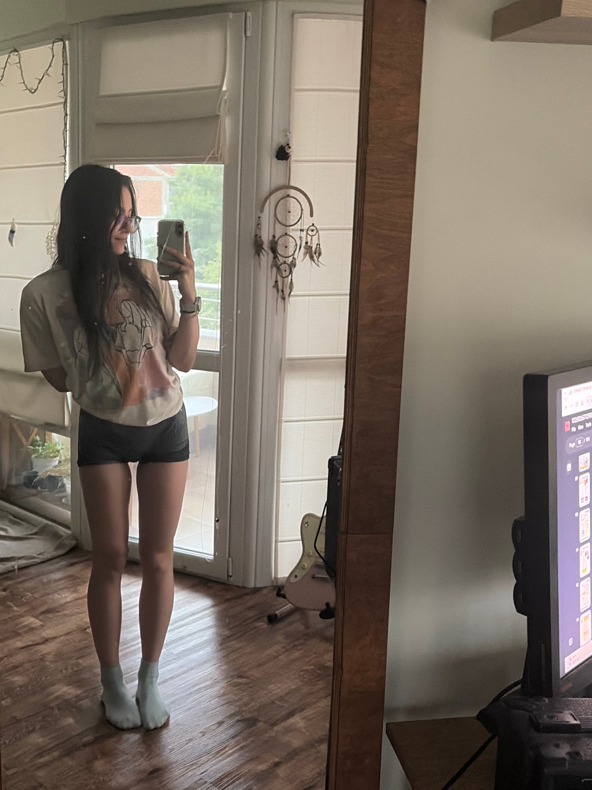 Mirror selfies at home with a cloudy city backdrop